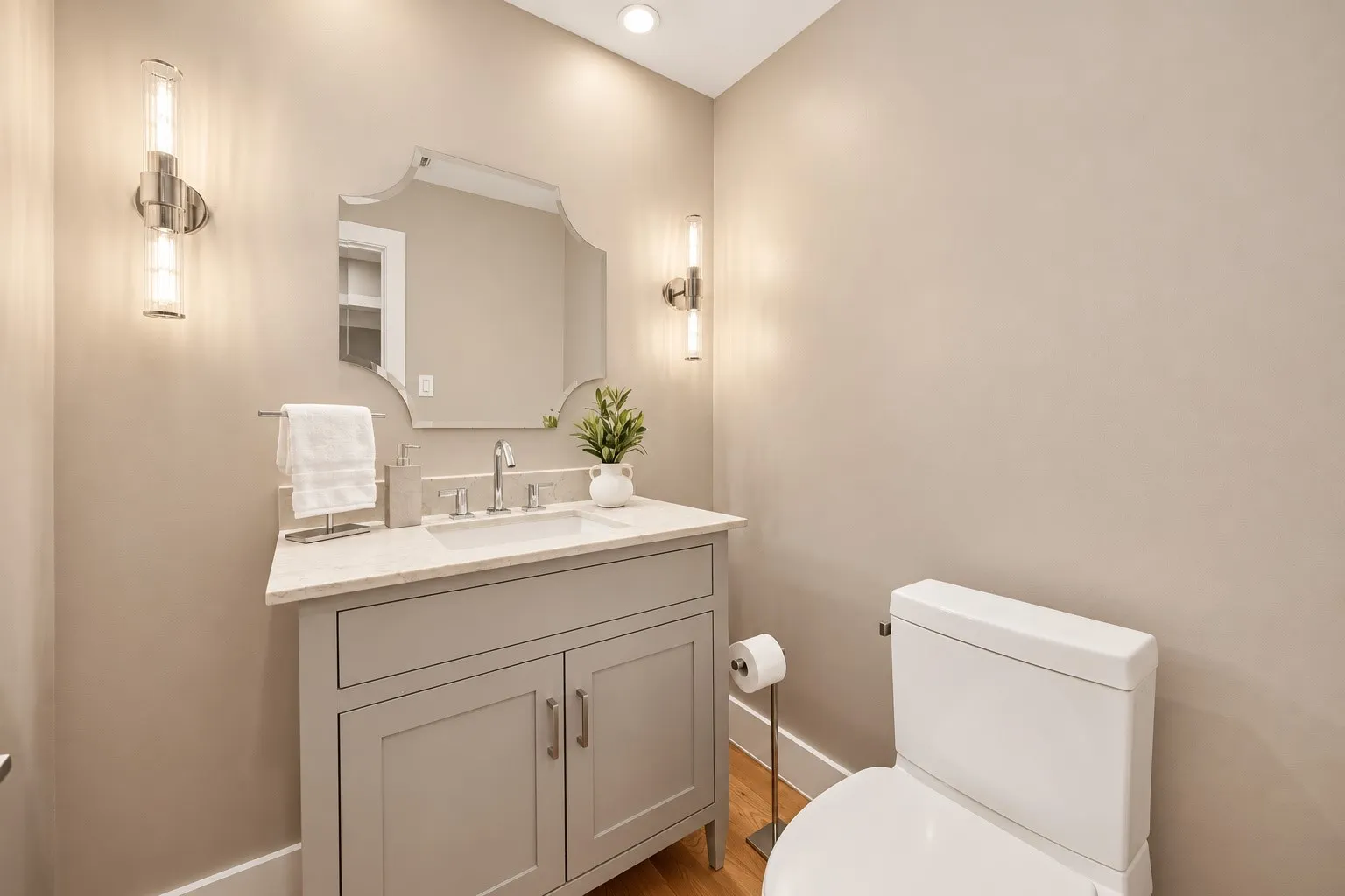 Powder Bathroom decorative wall mirror and dual brushed-nickel wall sconces