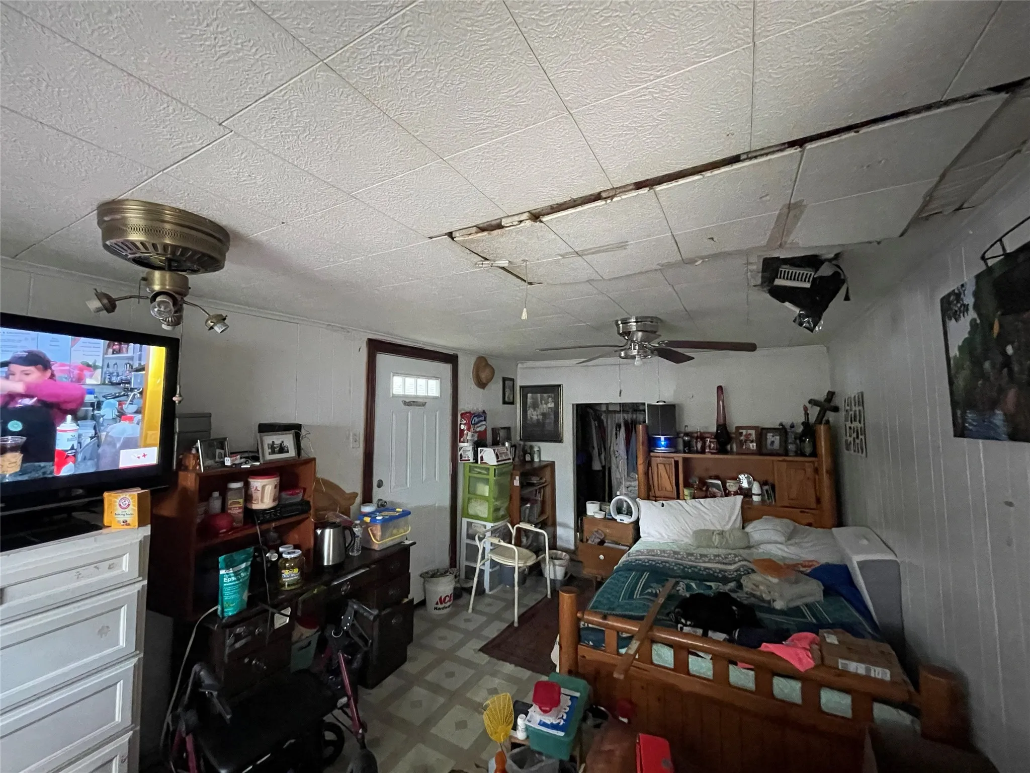 Room featuring a six-panel exterior entry door and two ceiling-mounted fans
