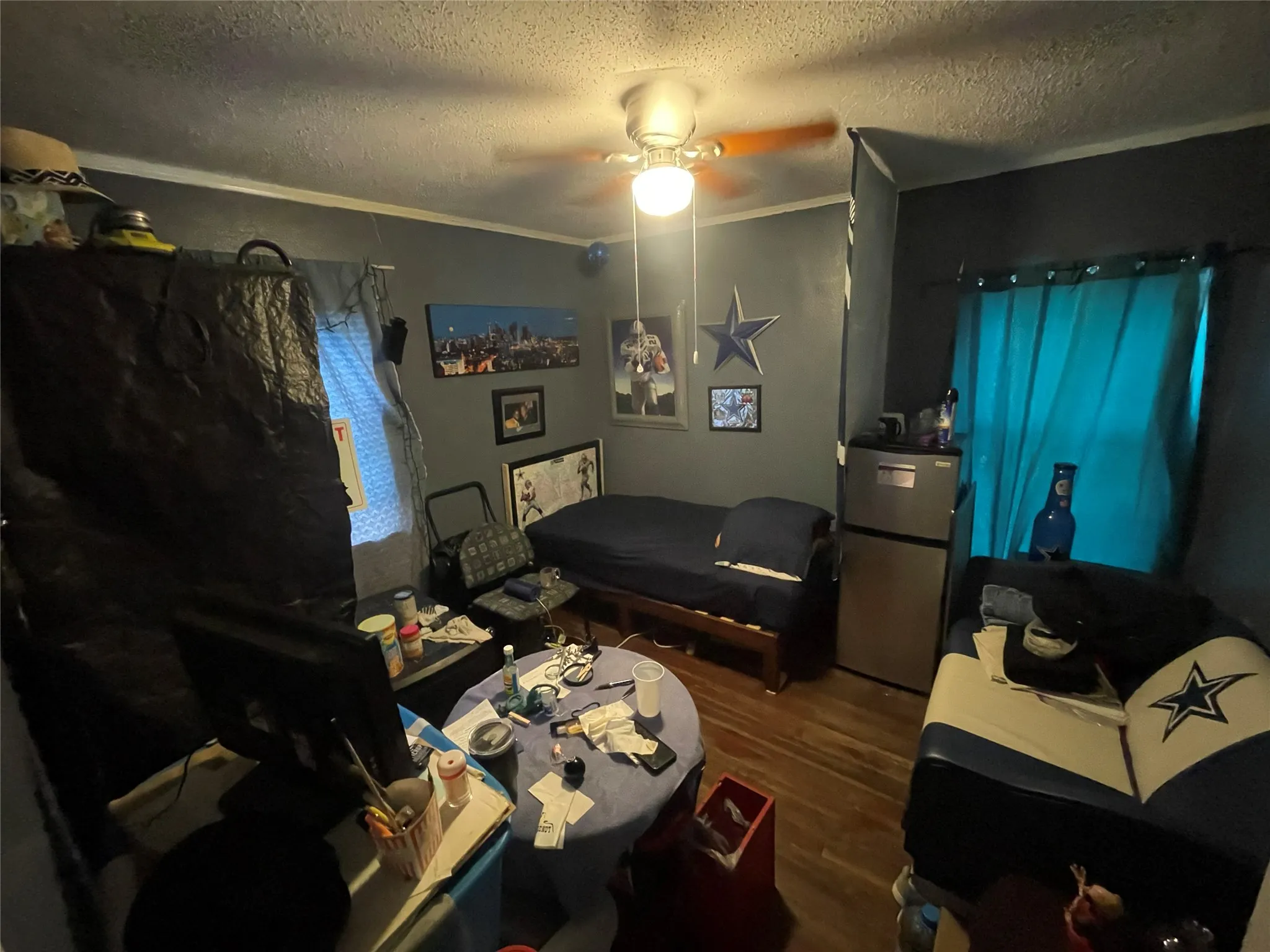 Interior room featuring wood-finish flooring and a central ceiling fan with integrated lighting
