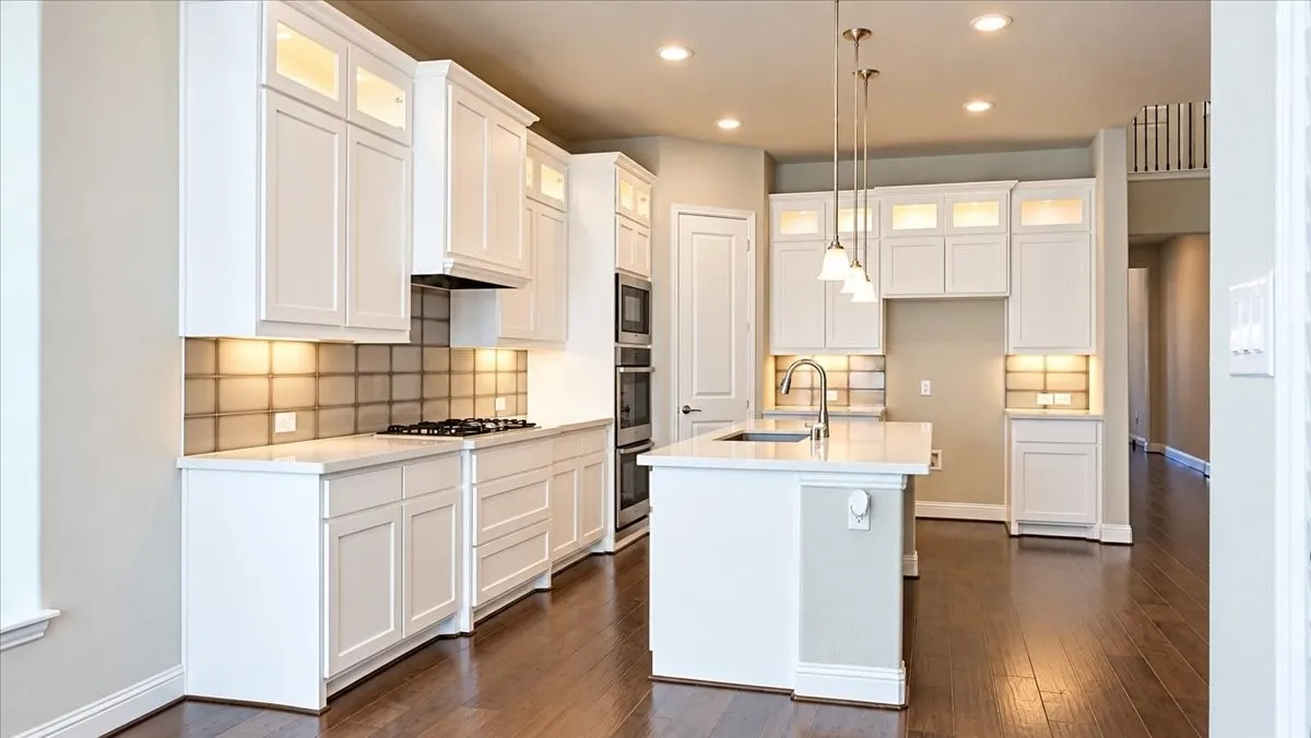 Kitchen featuring white shaker-style cabinetry, a central island with a quartz countertop, wood-finish flooring, built-in double wall ovens, and a tile backsplash
