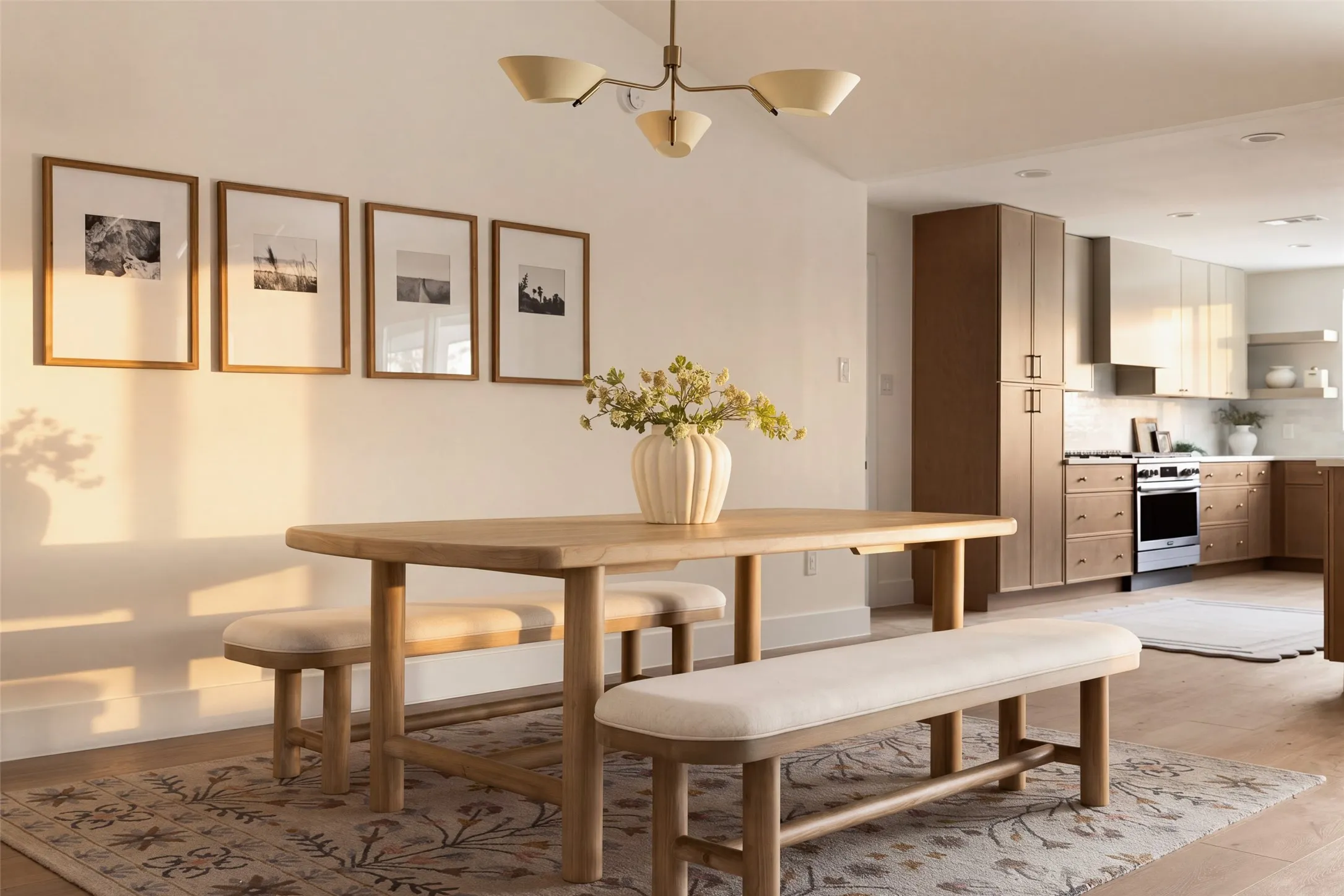 Open living and dining areas with vaulted ceilings, wood-like flooring, modern lighting, flowing into the updated kitchen.