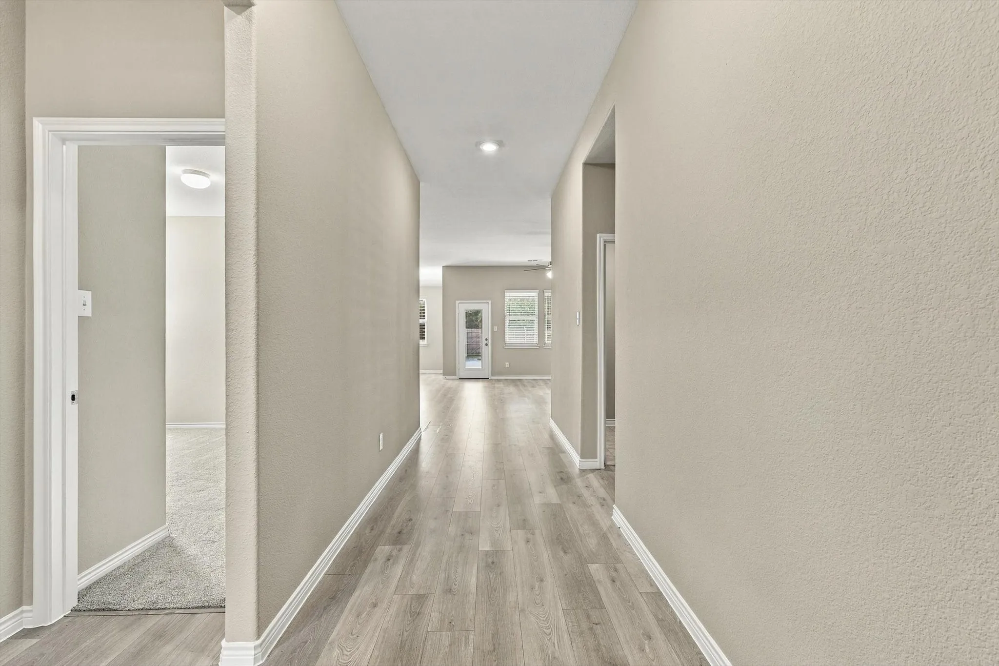 Coming in the entry, Hallway to the open kitchen, living area. To the left is the doorway to bedroom 3