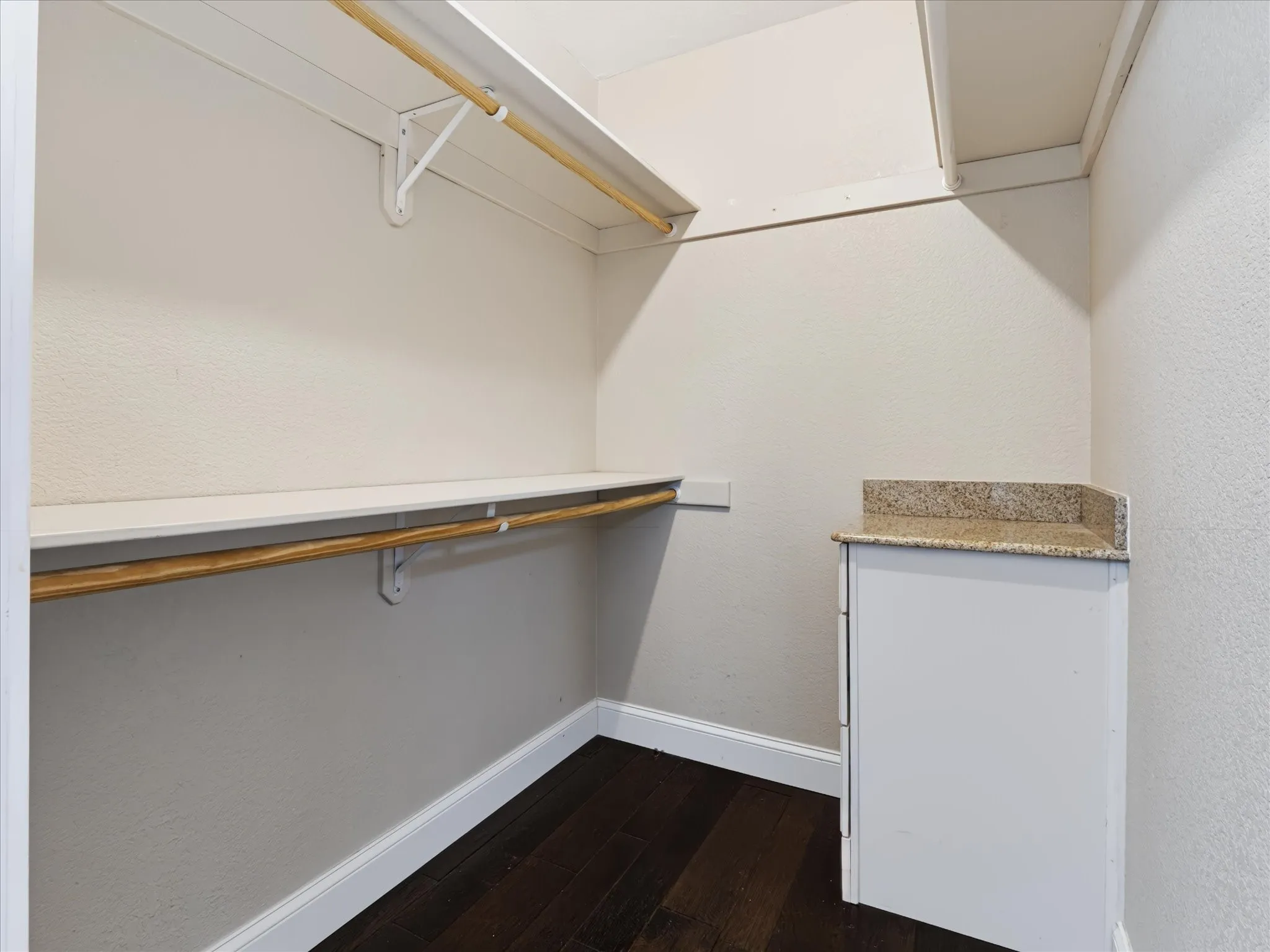 Primary Bedroom Walk in closet with built in dresser drawers