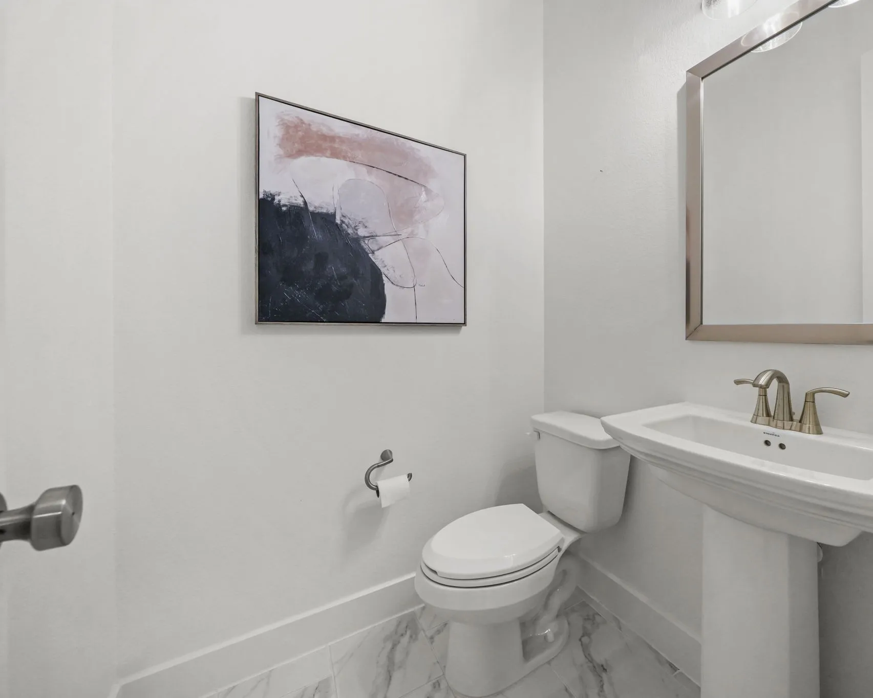 Powder room featuring a pedestal sink, metallic finish faucet, ceramic tile flooring, and wall-mounted hardware