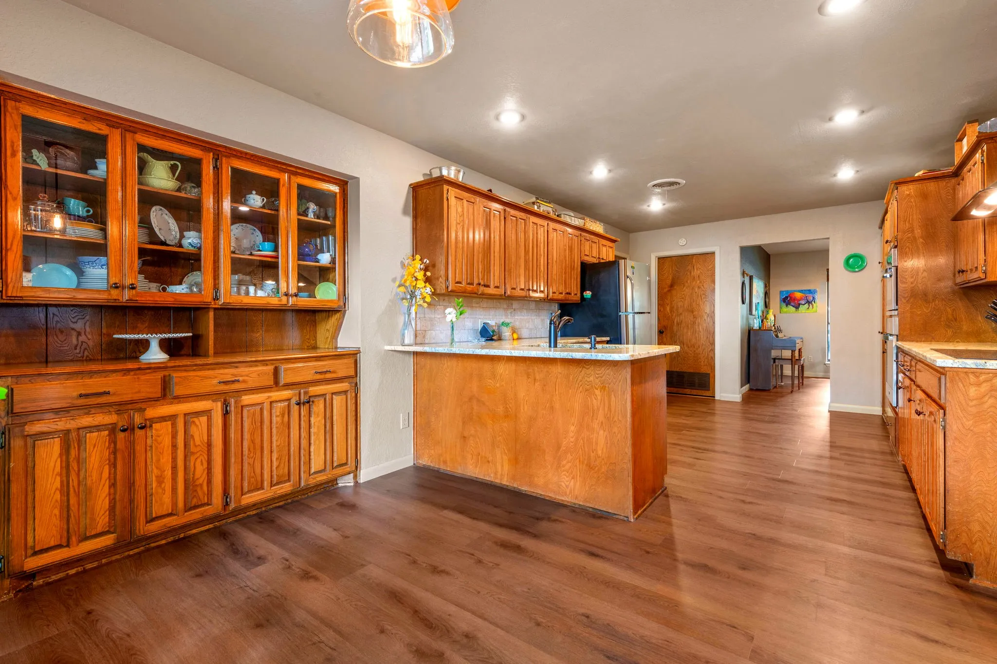 A built-in hutch with glass-front cabinets adds timeless charm and display space right in the kitchen.