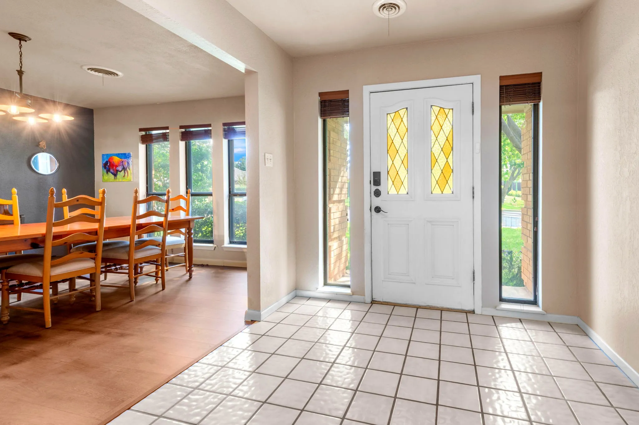 Step inside to a bright foyer where golden stained glass lights the way to the dining room.