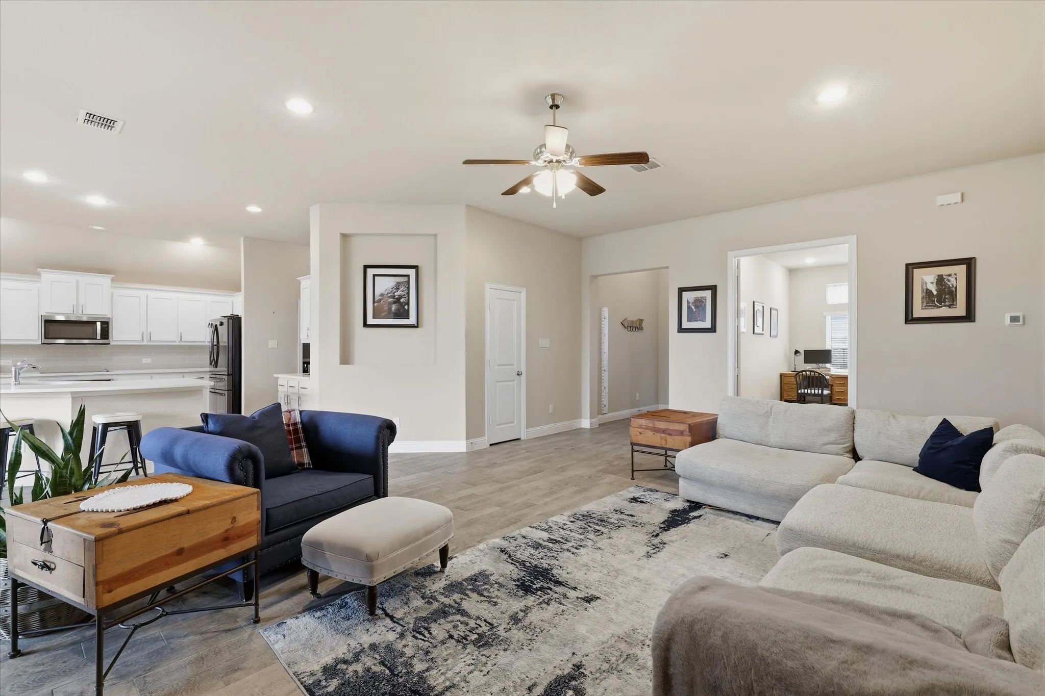 Living area open to kitchen and dining.