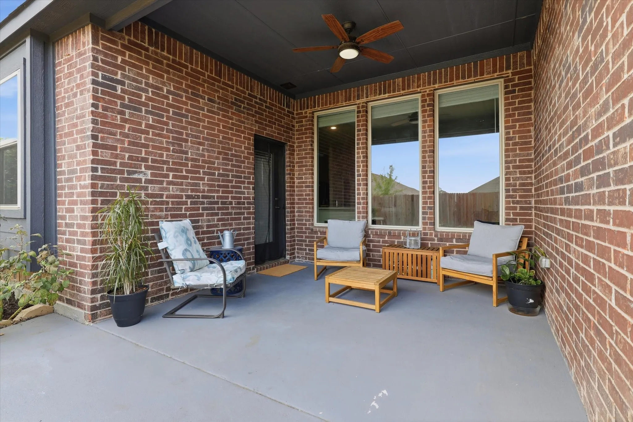 Covered patio and extended concrete for outdoor grilling.