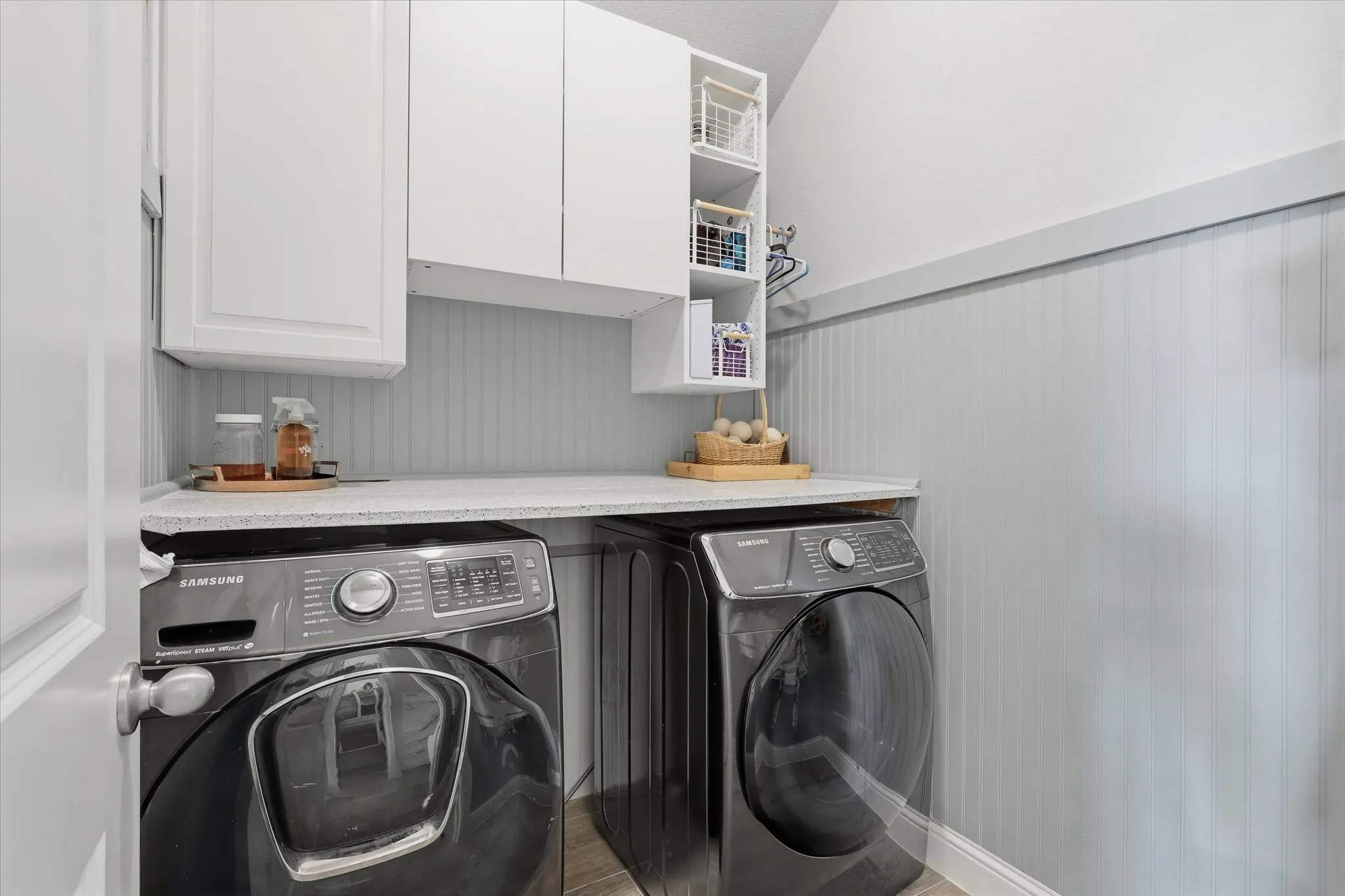 Full size washer drye area with custom bead board paneling.