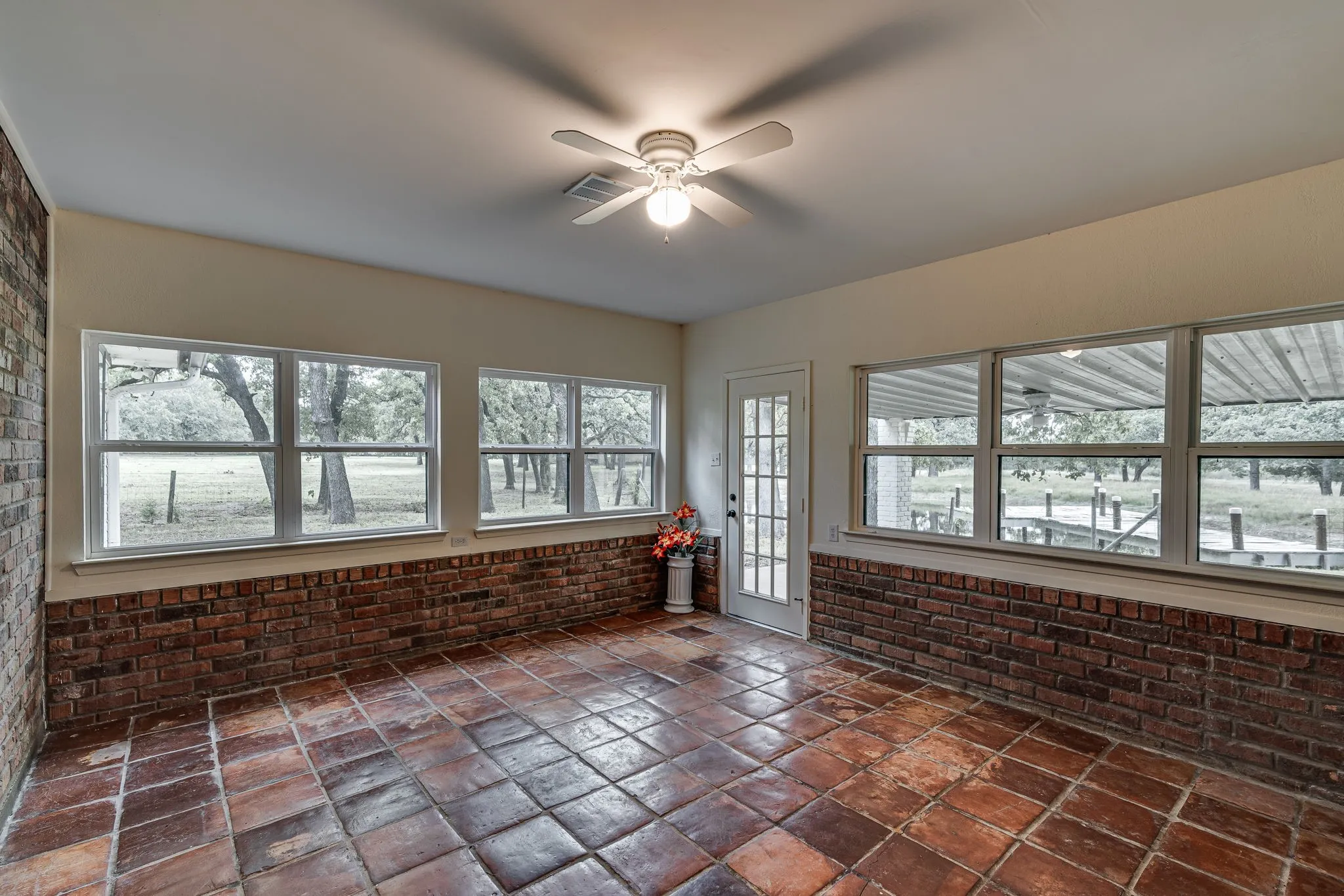 Enclosed & air conditioned sun room with view of dock & pond