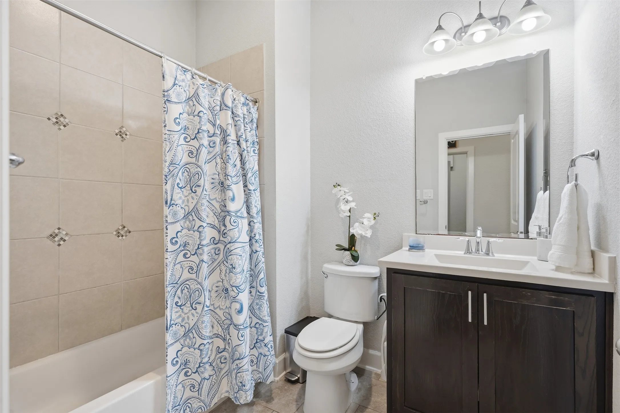 Bathroom in hall near middle bedroom.