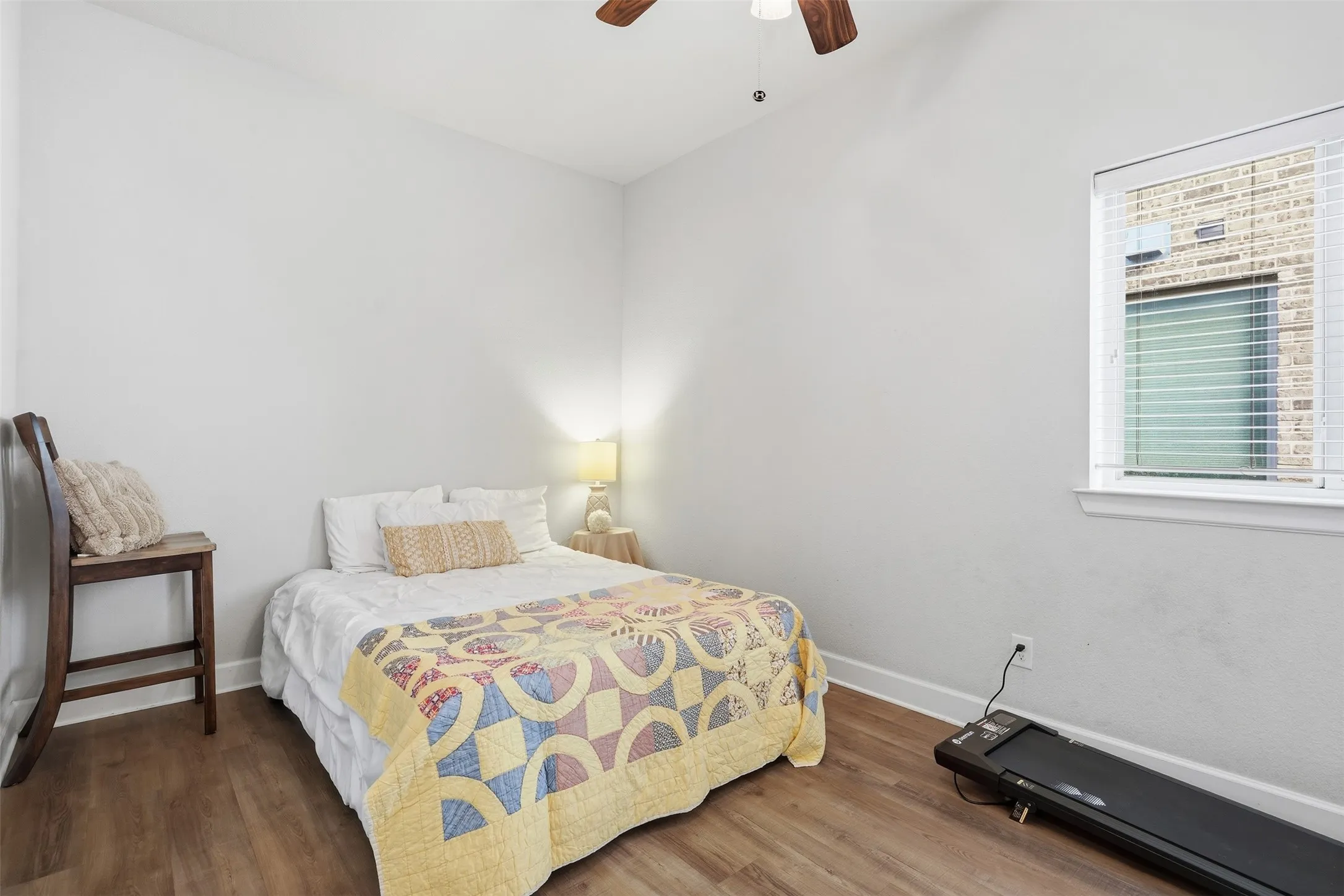 Wood-finish flooring, ceiling fan in middle of the home.