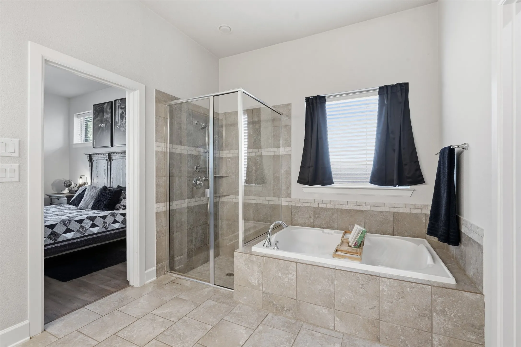 Bathroom featuring a deep soaking tub and separate glass shower