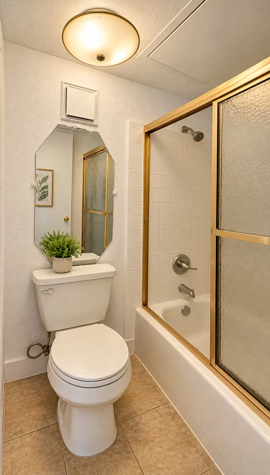 Bathroom featuring a tub-shower combination with sliding glass doors, ceramic tile flooring, octagonal wall mirror, and flush-mount lighting fixture