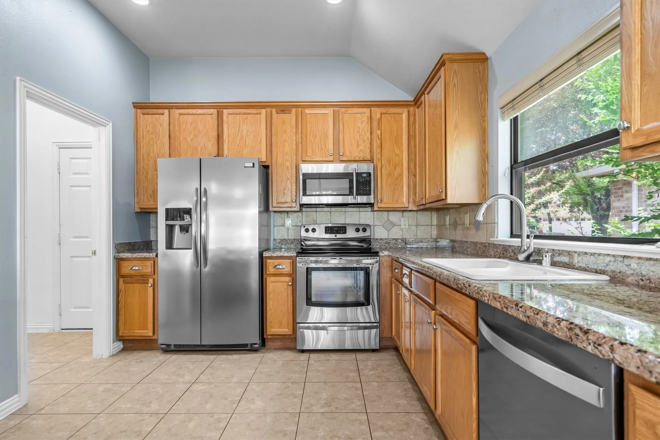 The well appointed kitchen with oak cabinets and beautiful granite counter tops is open to the action in the living room and perfect for entertaining
