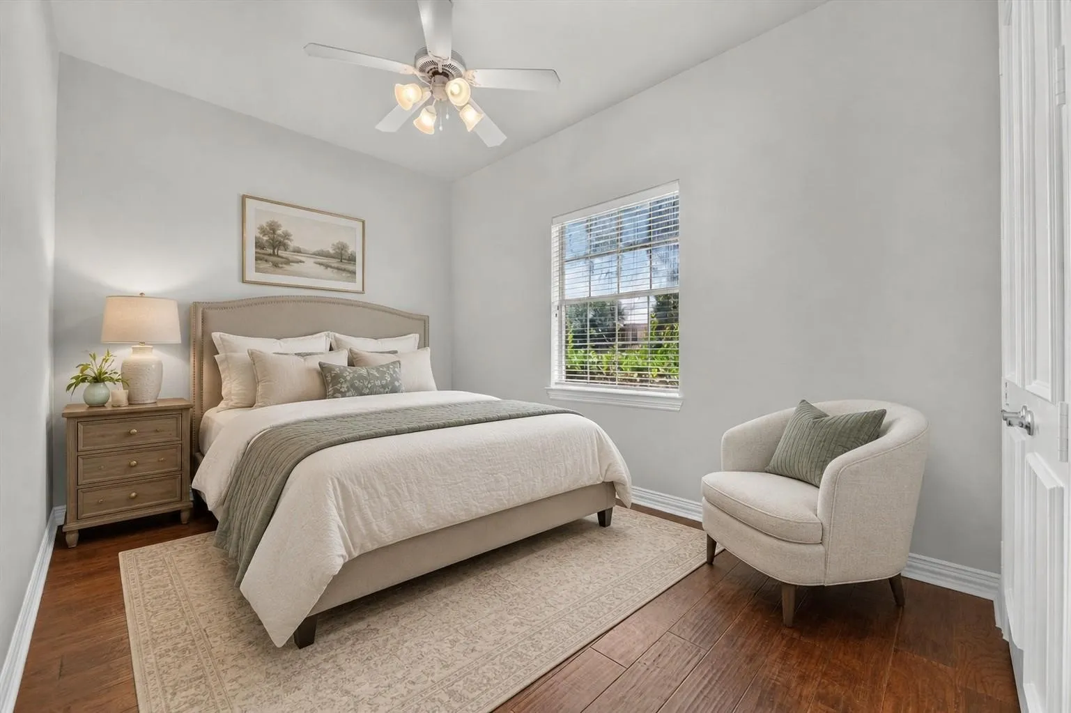 Bedroom featuring wood-finish flooring, a multi-light ceiling fan, and a window with blinds