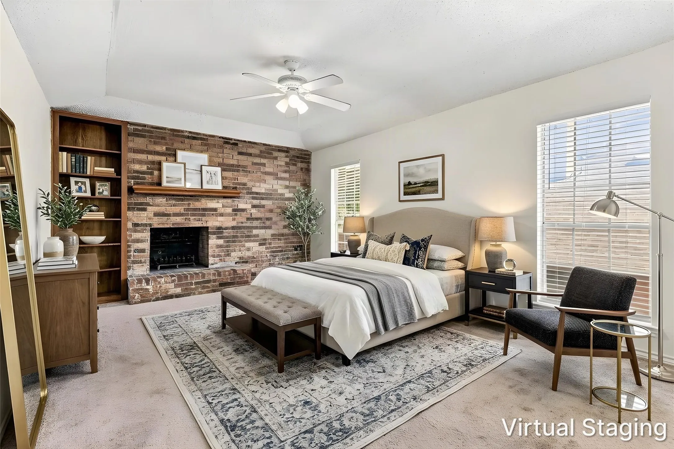 Exposed brick fireplace with a wood mantel, built-in floor-to-ceiling shelving, tray ceiling, and a ceiling fan with integrated lighting