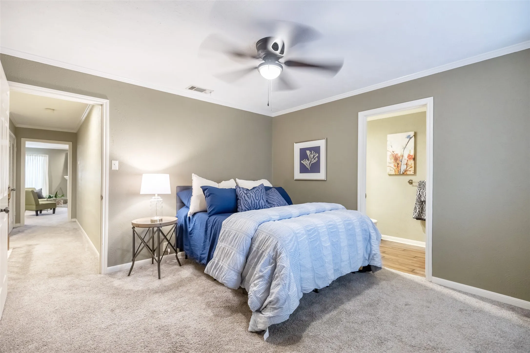Neutral-toned interior featuring wall-to-wall carpeting and a central ceiling fan with an integrated light fixture