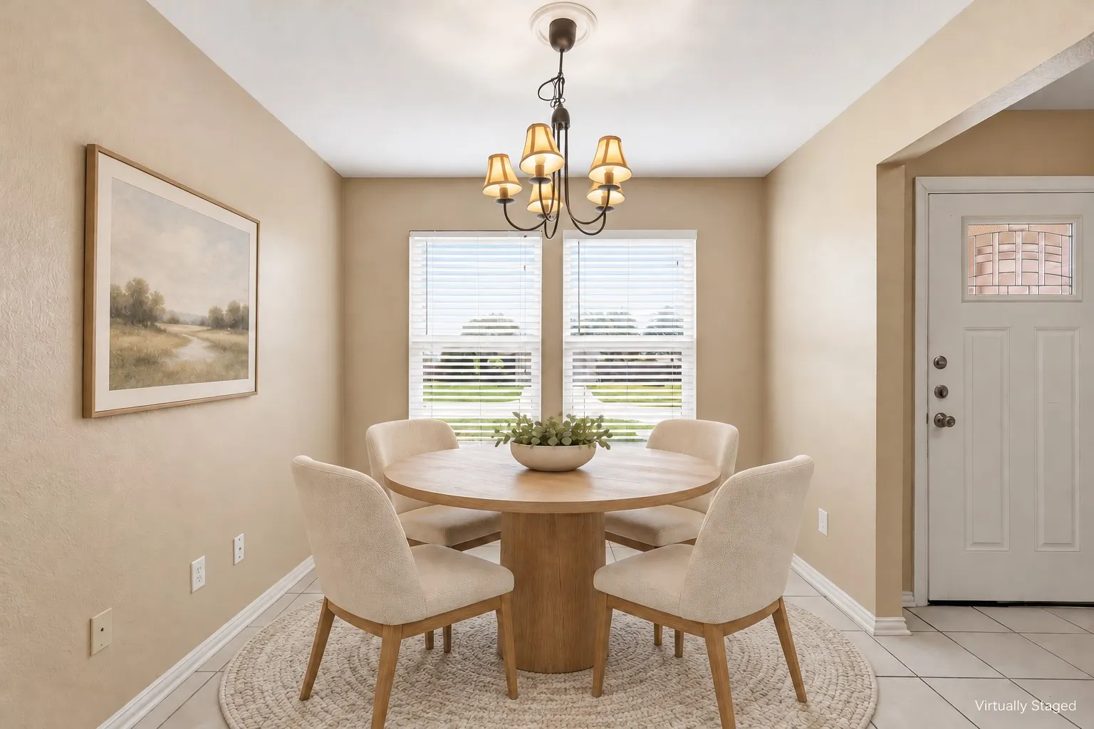 Neutral wall tones, dual windows with horizontal blinds, six-light iron chandelier, and tile flooring