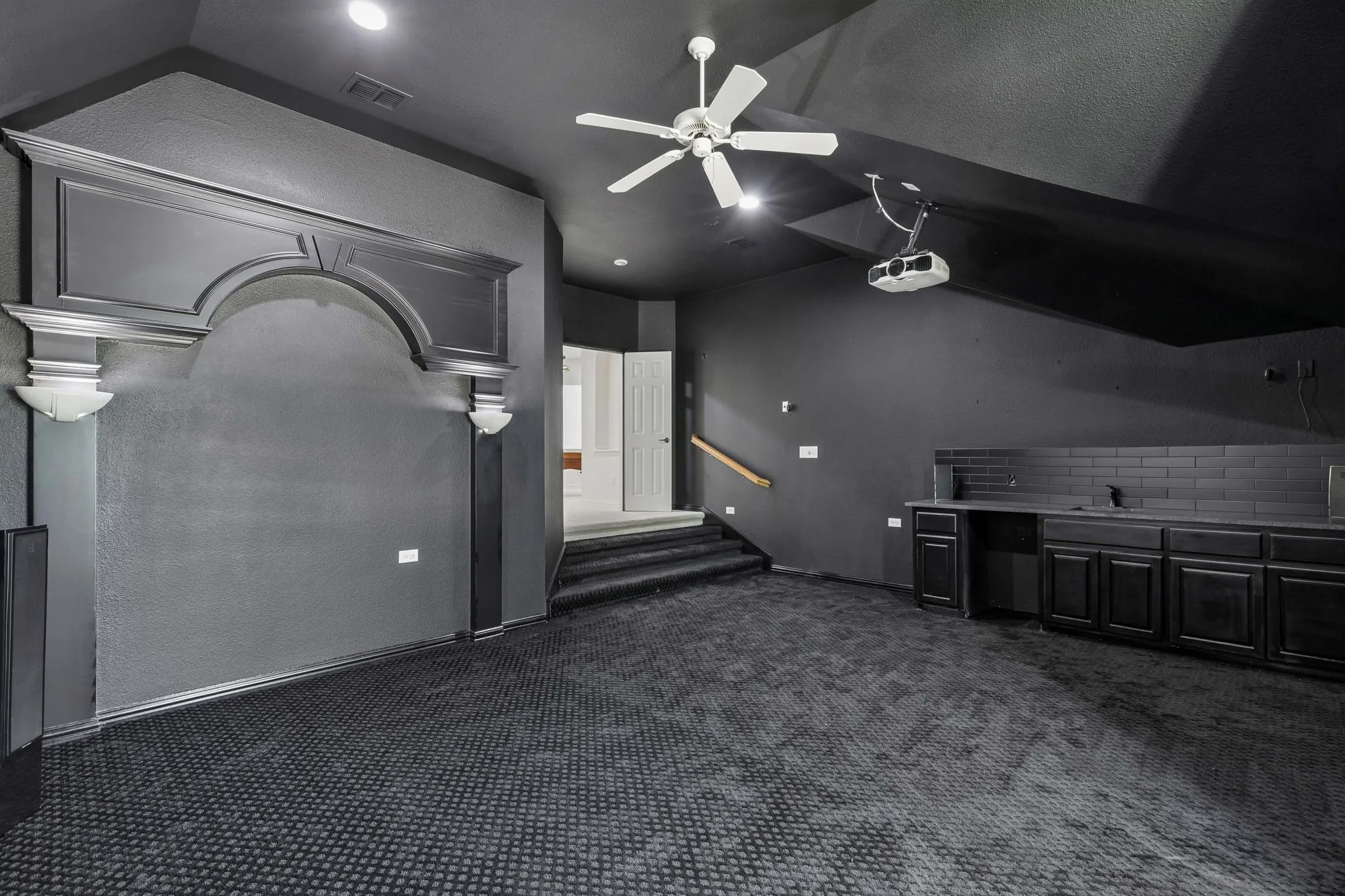 Media room has sink and built-ins for snacking.
