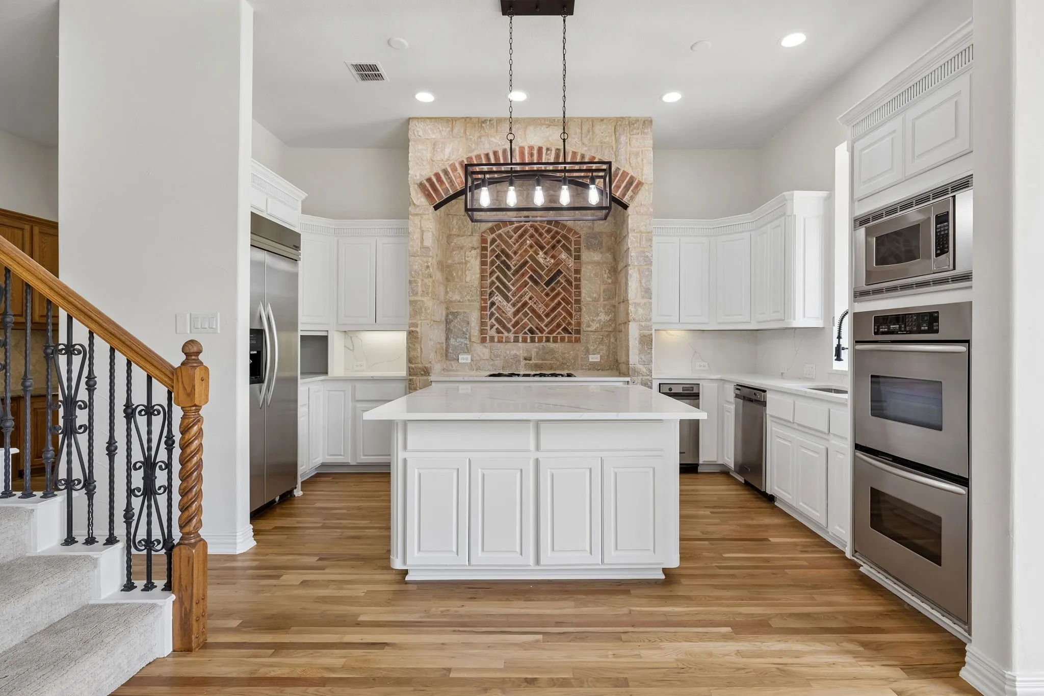 The gourmet kitchen is at the heart of the home with large central island and new countertops.