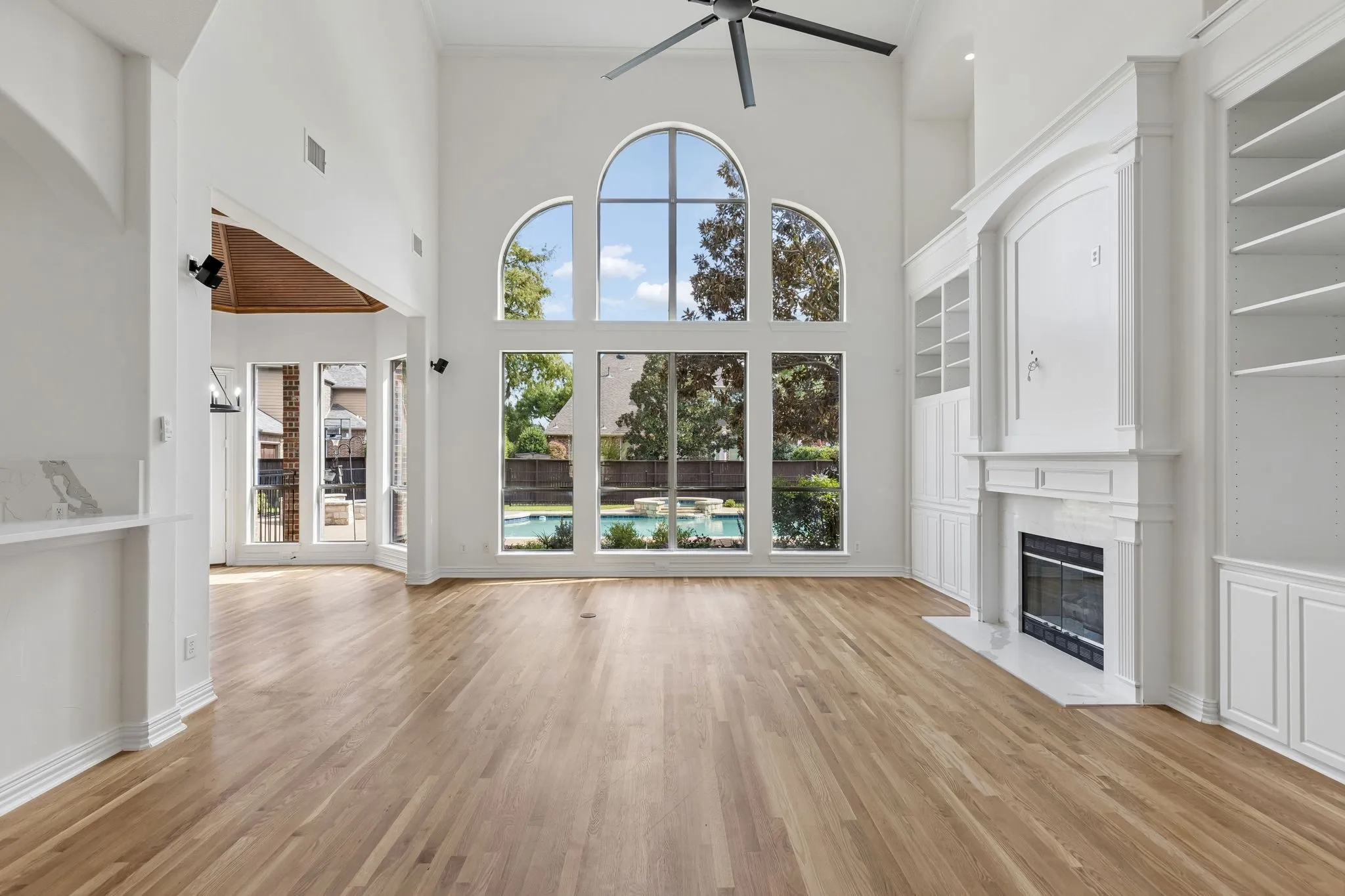Family room with wall of windows overlooking the backyard.