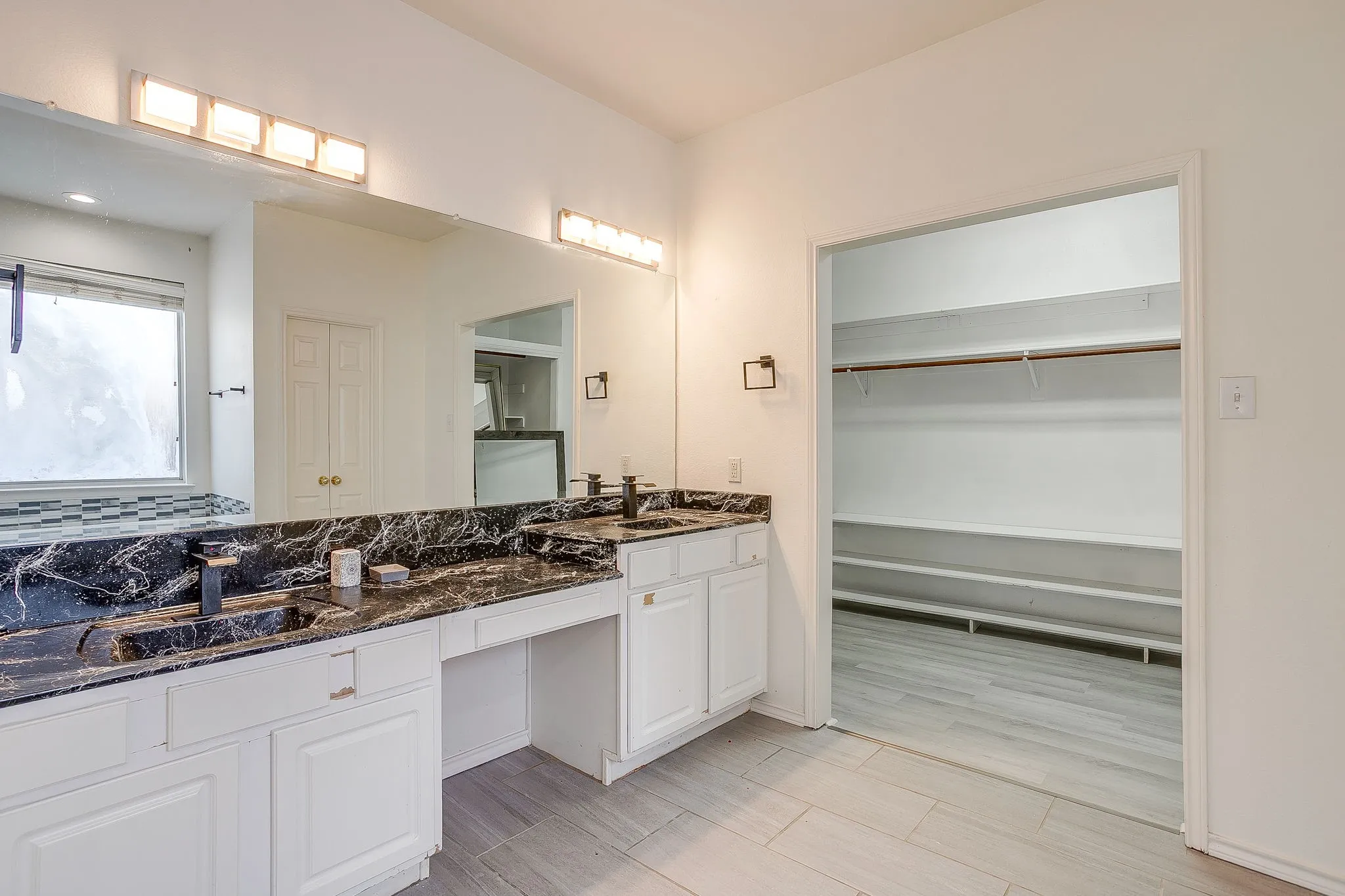 Jetted soaking tub with tile surround, a walk-in tiled shower.
