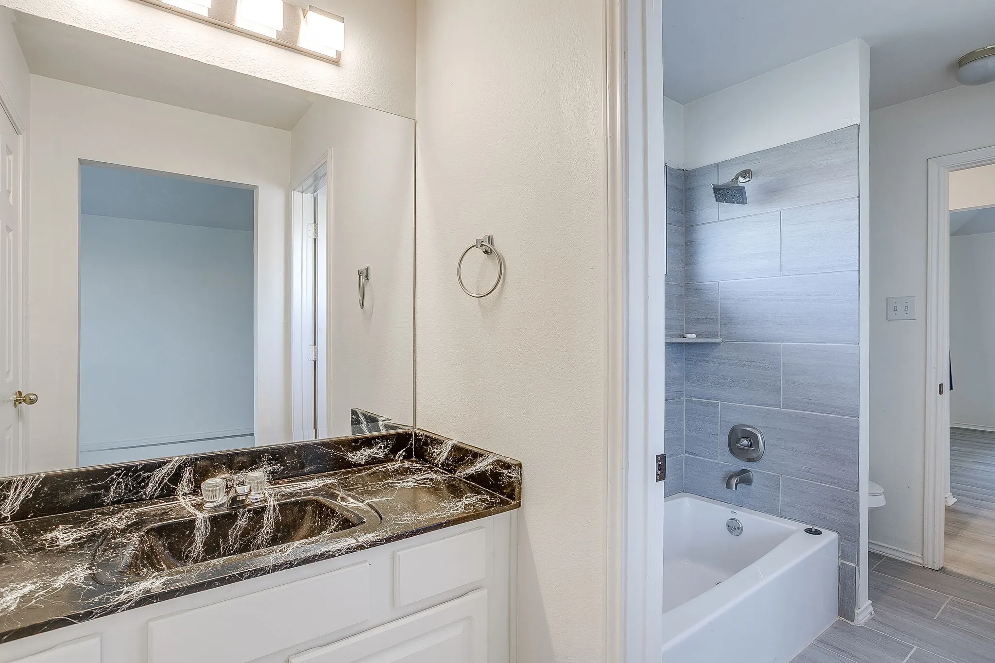 Shared tiled tub and shower combinationin Jack and Jill bathroom.