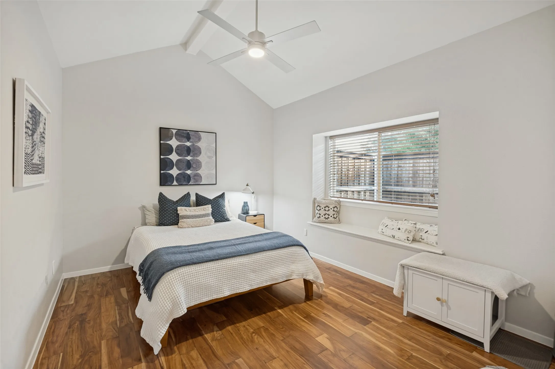 Bedroom with window seat and vaulted ceilings