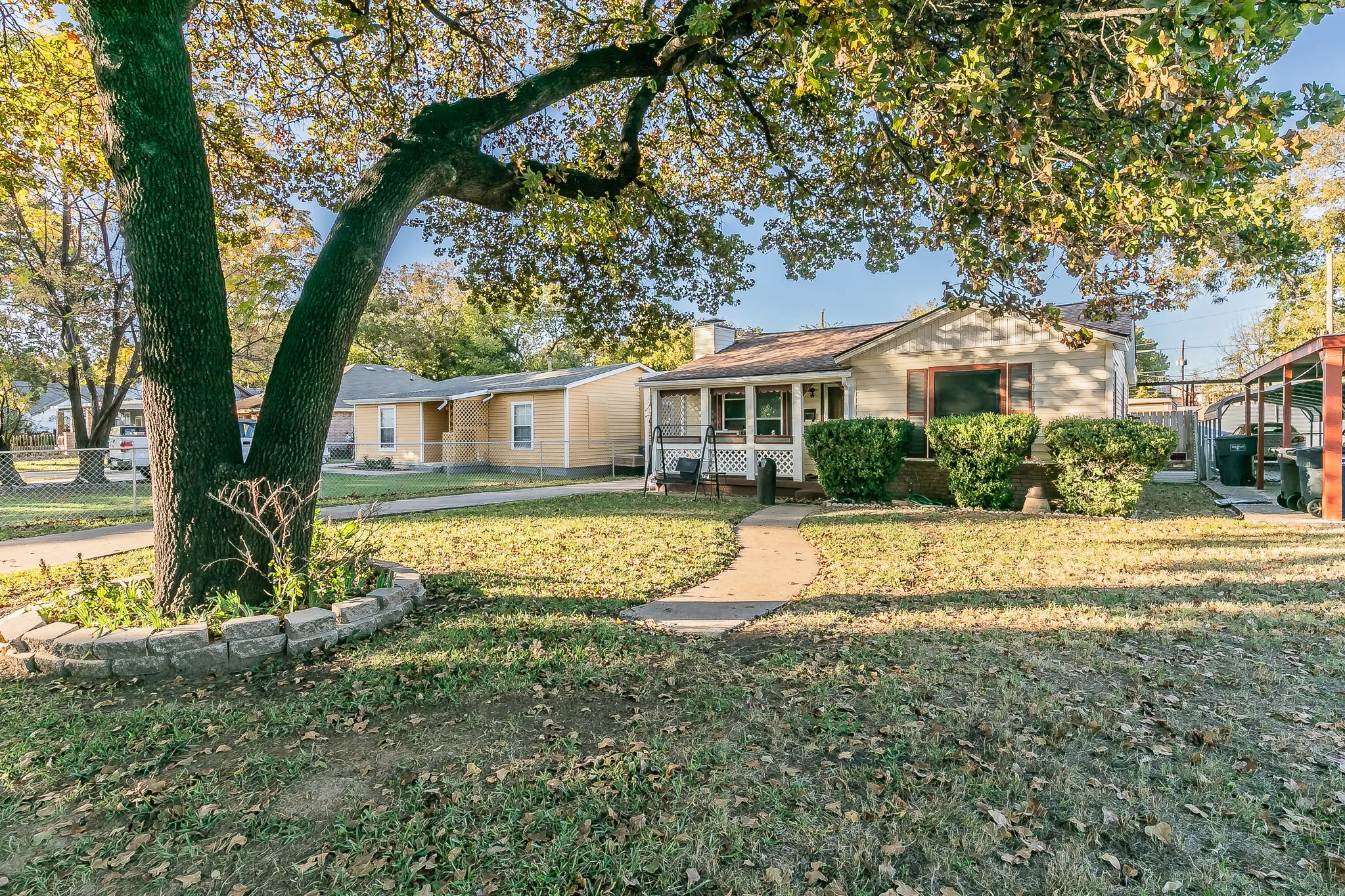 Ranch-style house featuring covered porch and a front yard