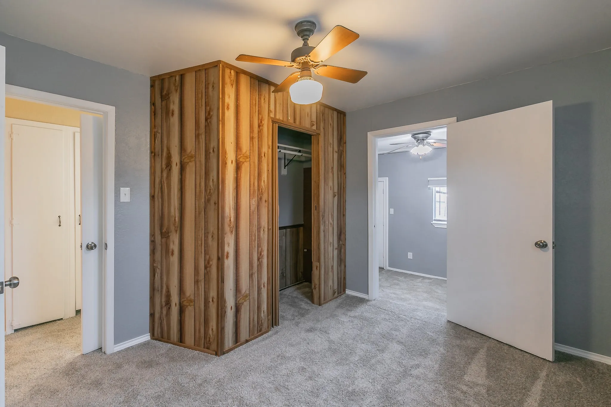 Unfurnished bedroom featuring light carpet, a closet, and ceiling fan
