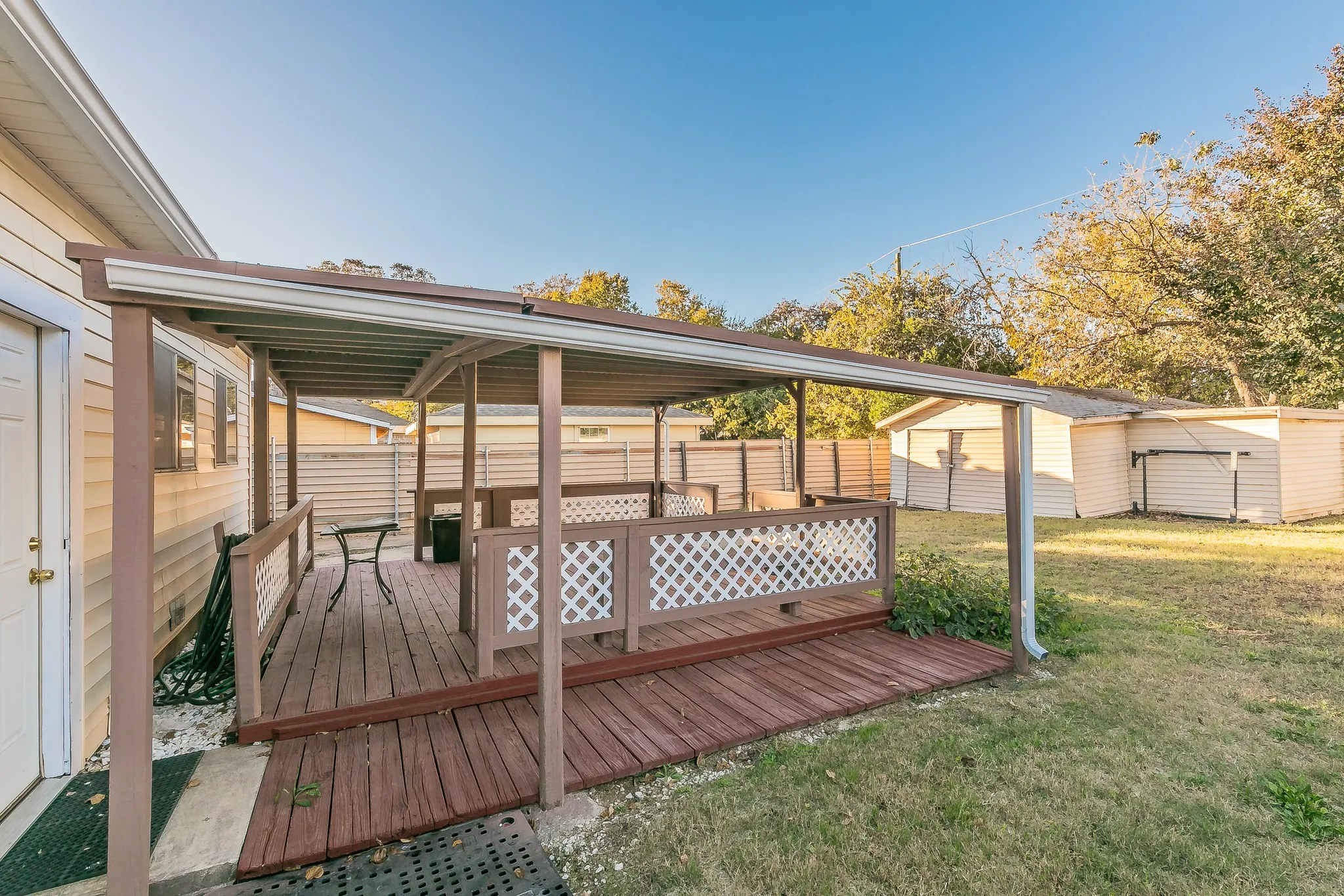 Deck featuring a yard and a storage unit