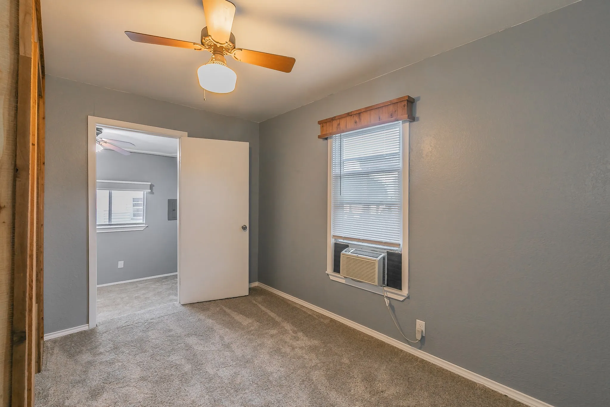 Spare room featuring light carpet and cooling unit