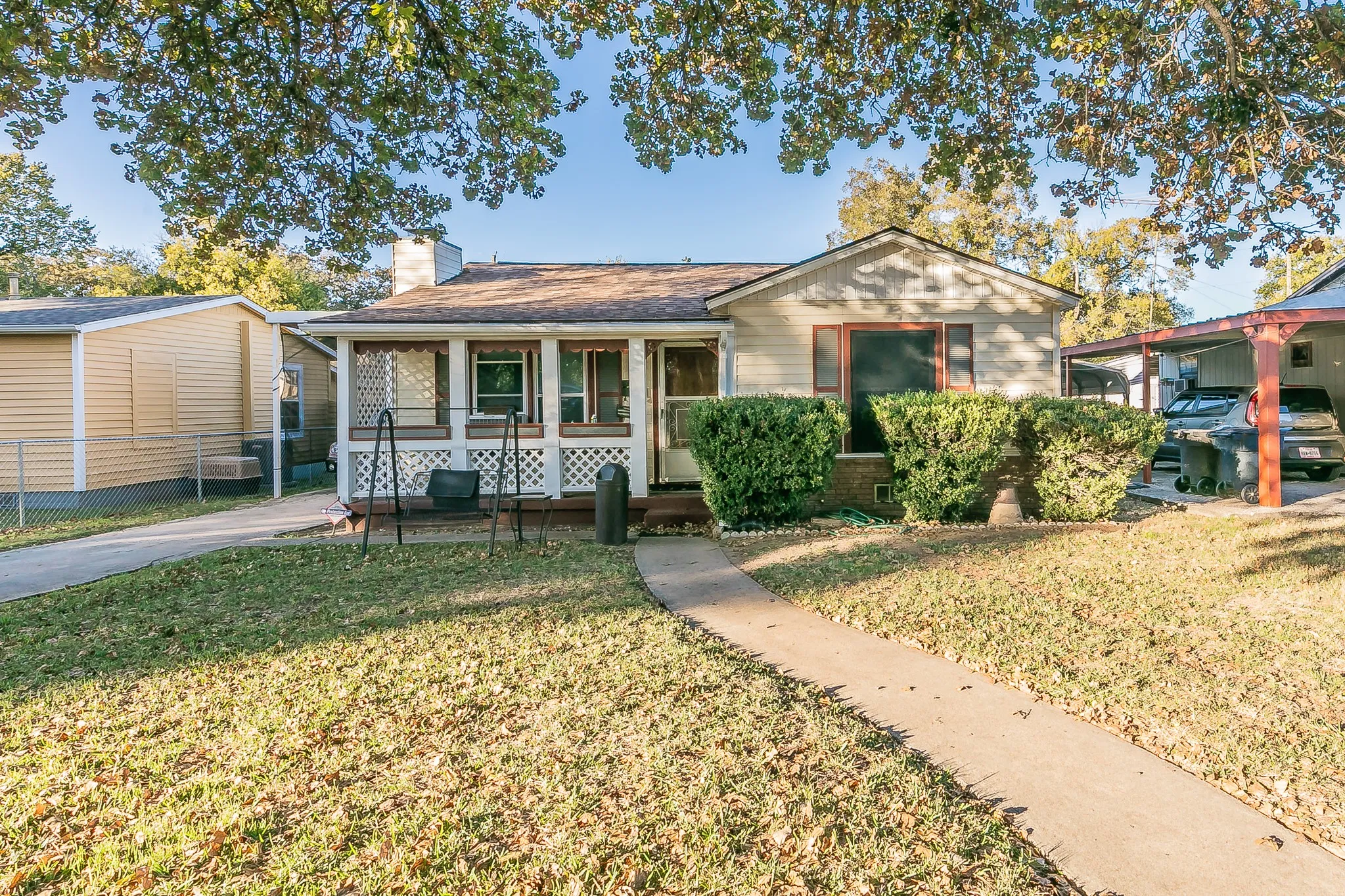 View of front of home with cooling unit, a front lawn, and a porch
