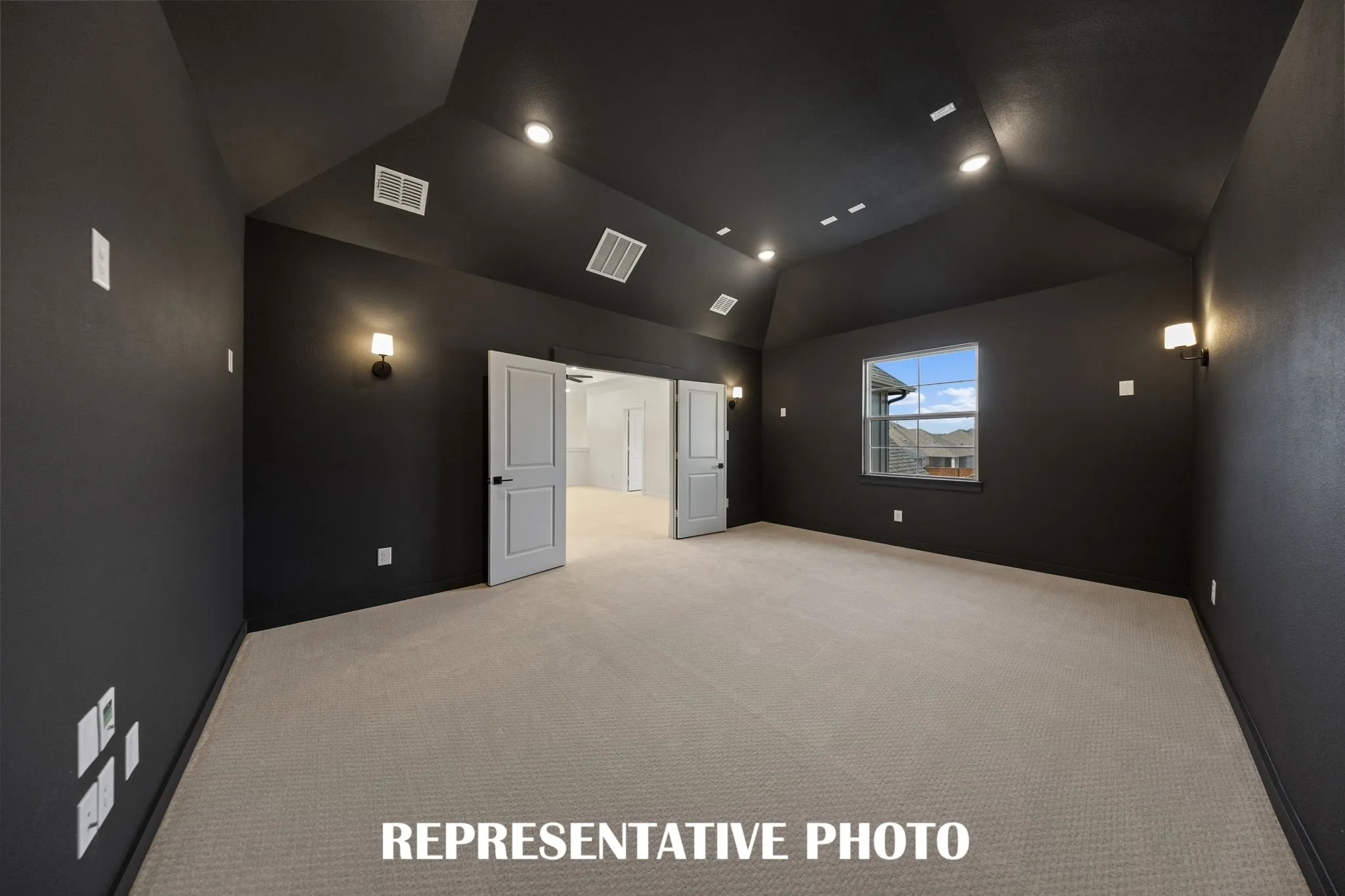 This spacious media room paired with adjacent game room create the ultimate family entertainment zone!  REPRESENTATIVE PHOTO