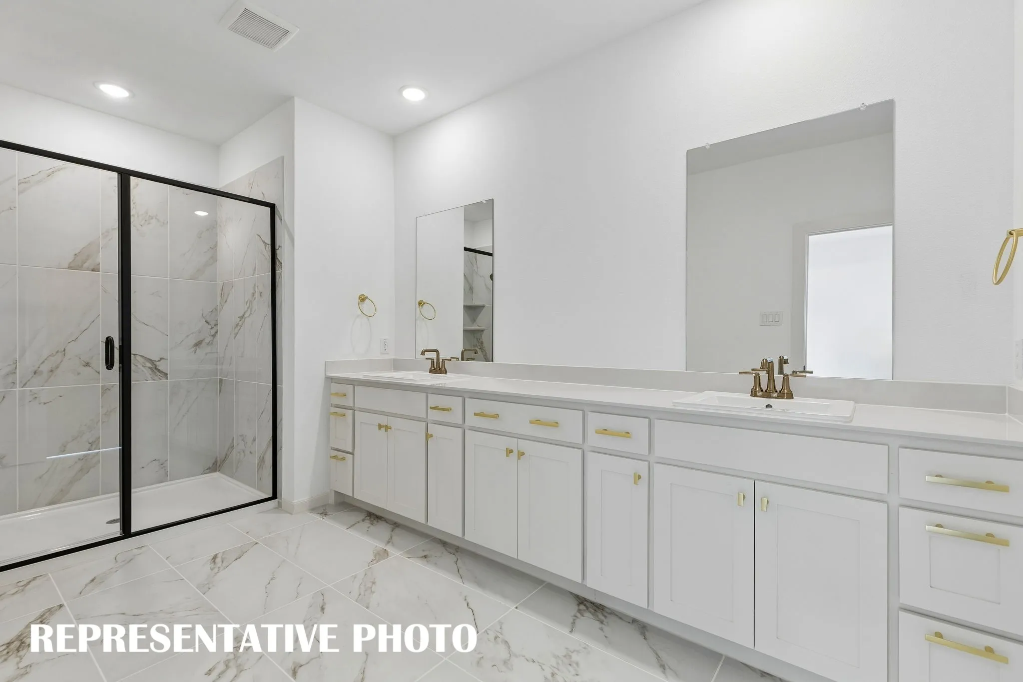 With a spacious walk in shower and plenty of cabinet & counter space, this owner's bath is a dream come true!  REPRESENTATIVE PHOTO