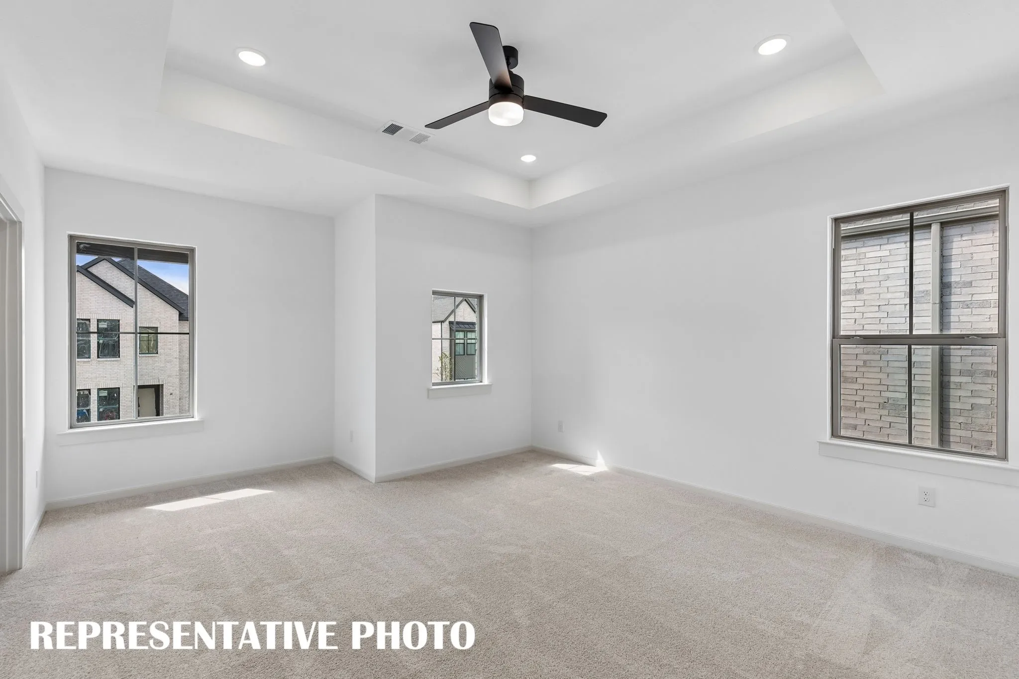 High ceilings, plush carpeting and plenty of natrual light, this owner's bedroom was designed for rest and relaxation.  REPRESENTATIVE PHOTO