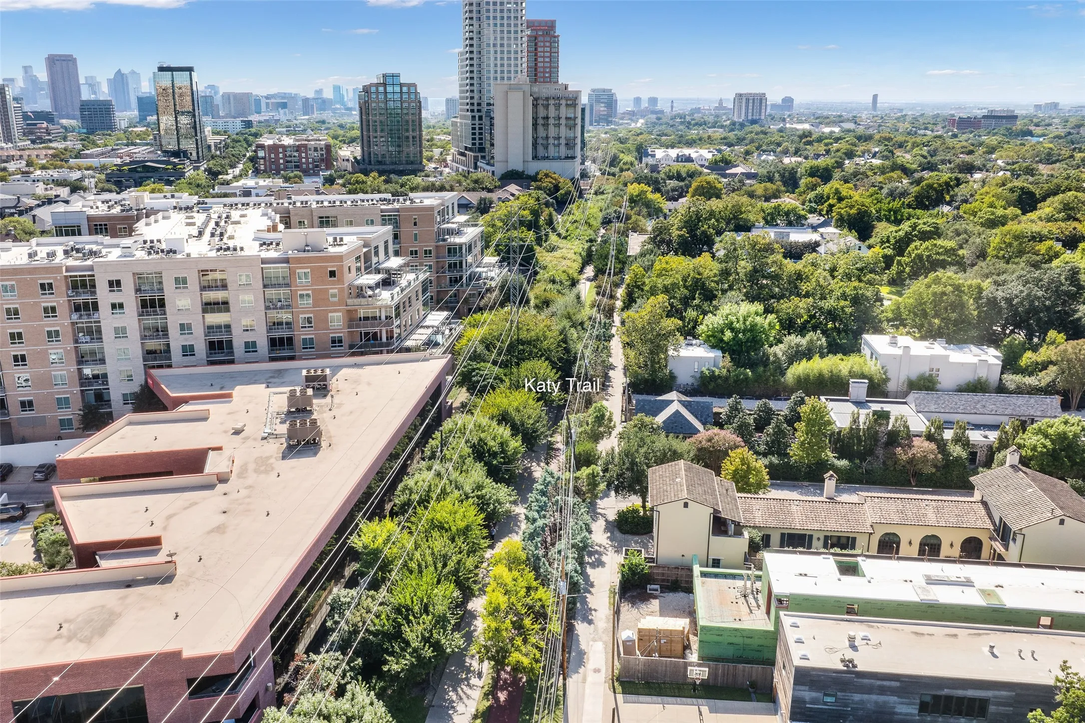 Aerial perspective highlighting proximity to the Katy Trail, surrounding tree canopy, and urban skyline