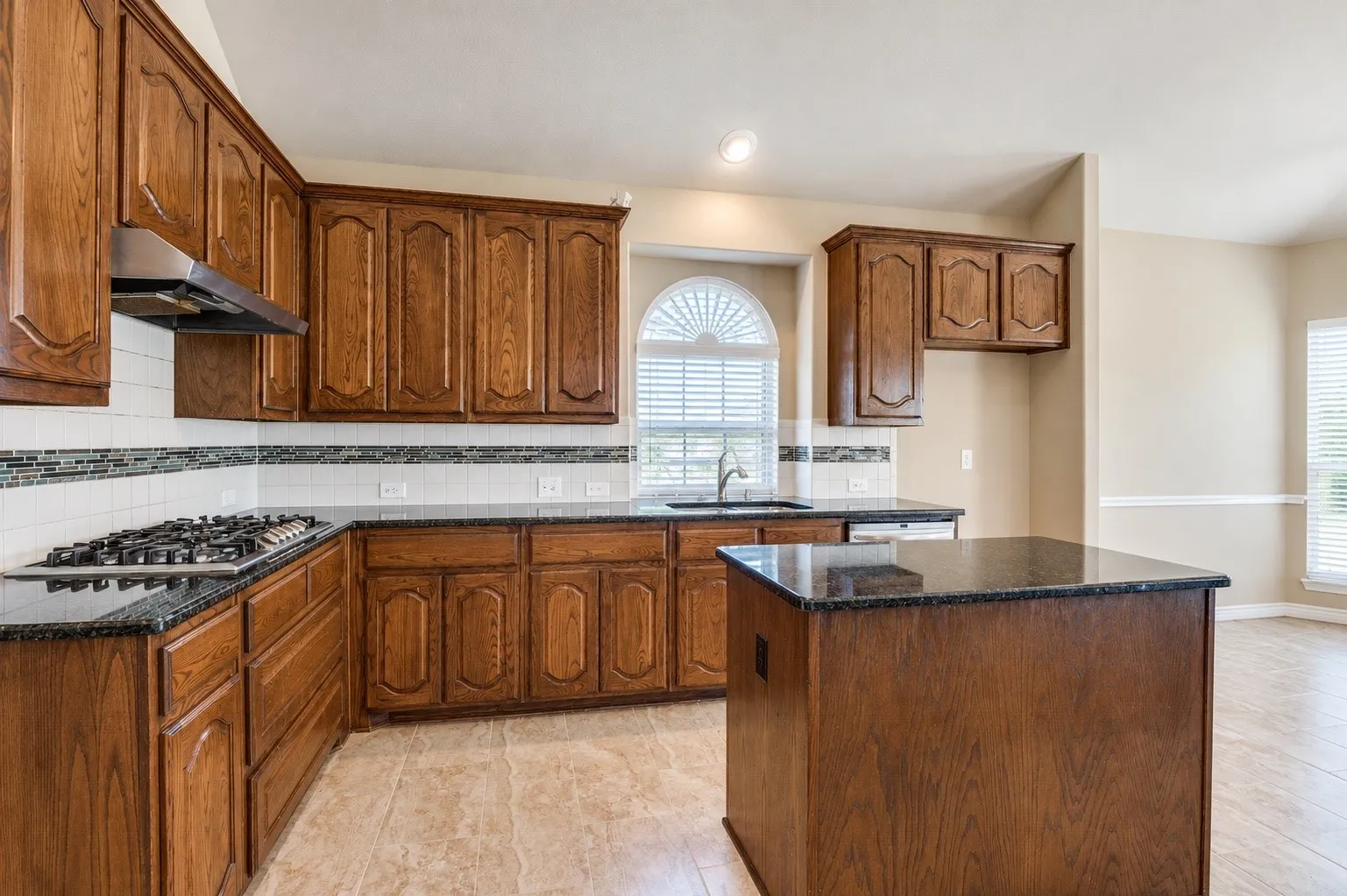 Expansive kitchen with rich wood word throughout & abundant natural light!