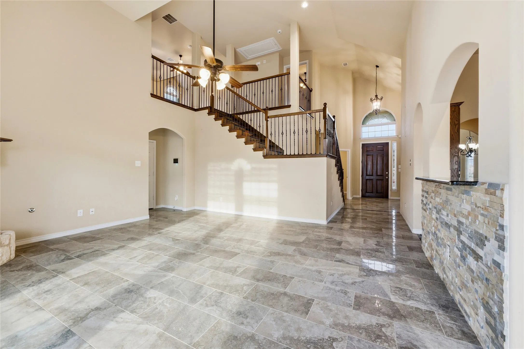 An inviting living room with soaring ceilings and abundant natural light.