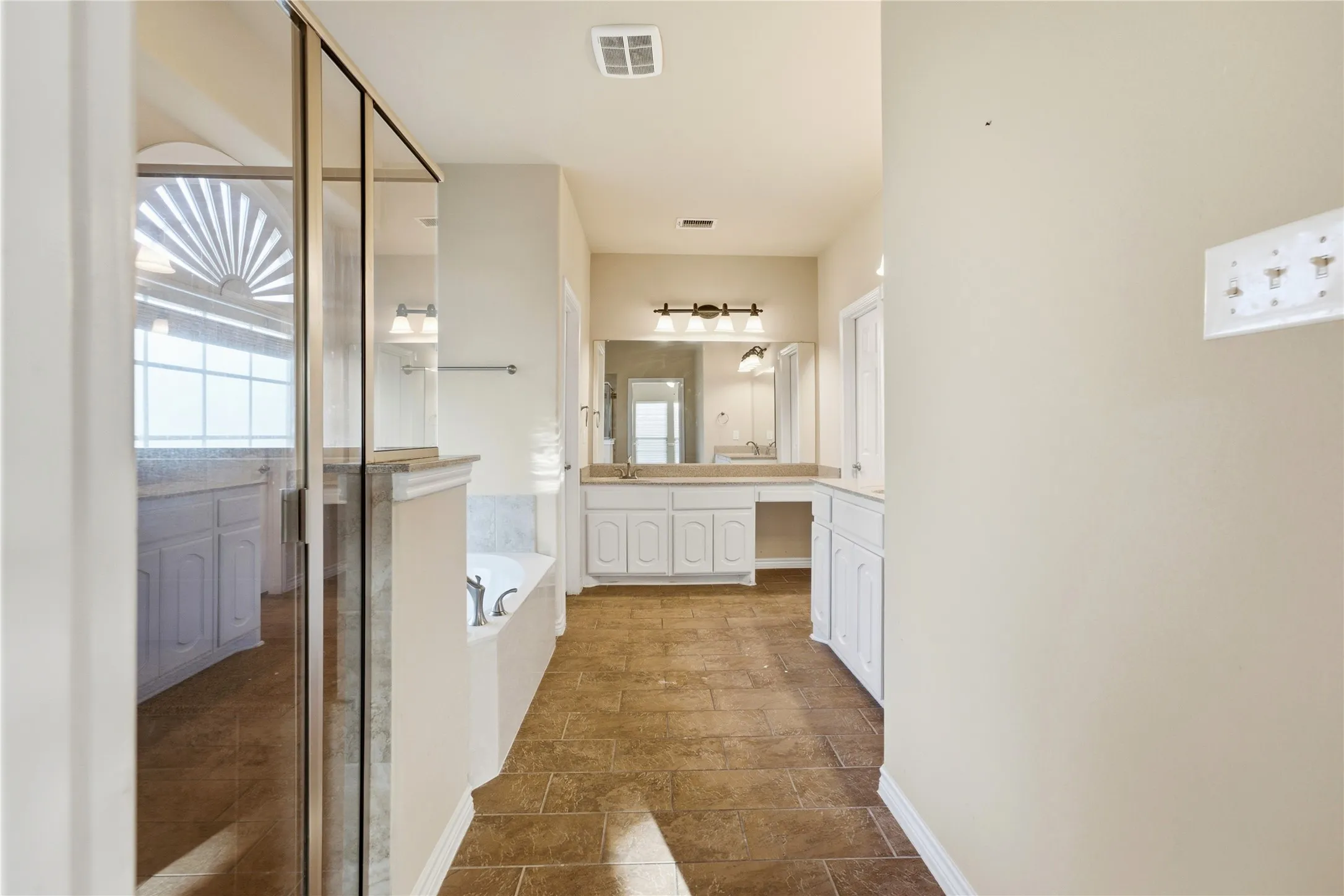 Luxurious primary en-suite featuring dual vanities and a separate soaking tub and walk-in shower.