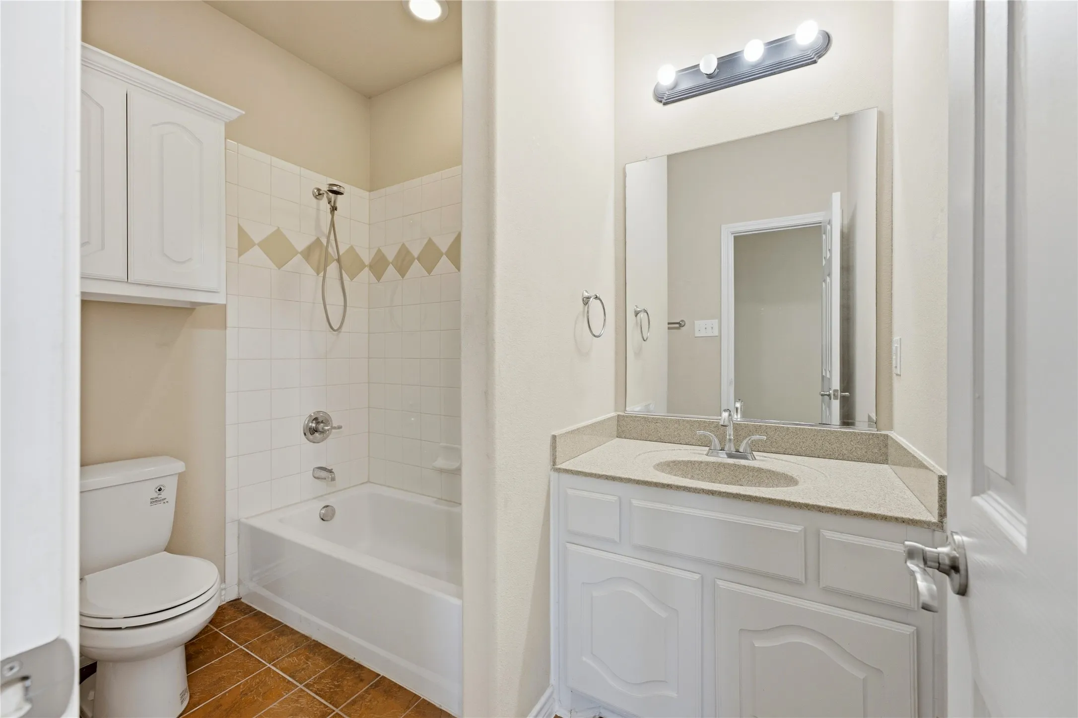 A convenient private bathroom complements the downstairs bedroom, ideal for a second primary suite or in-law retreat.