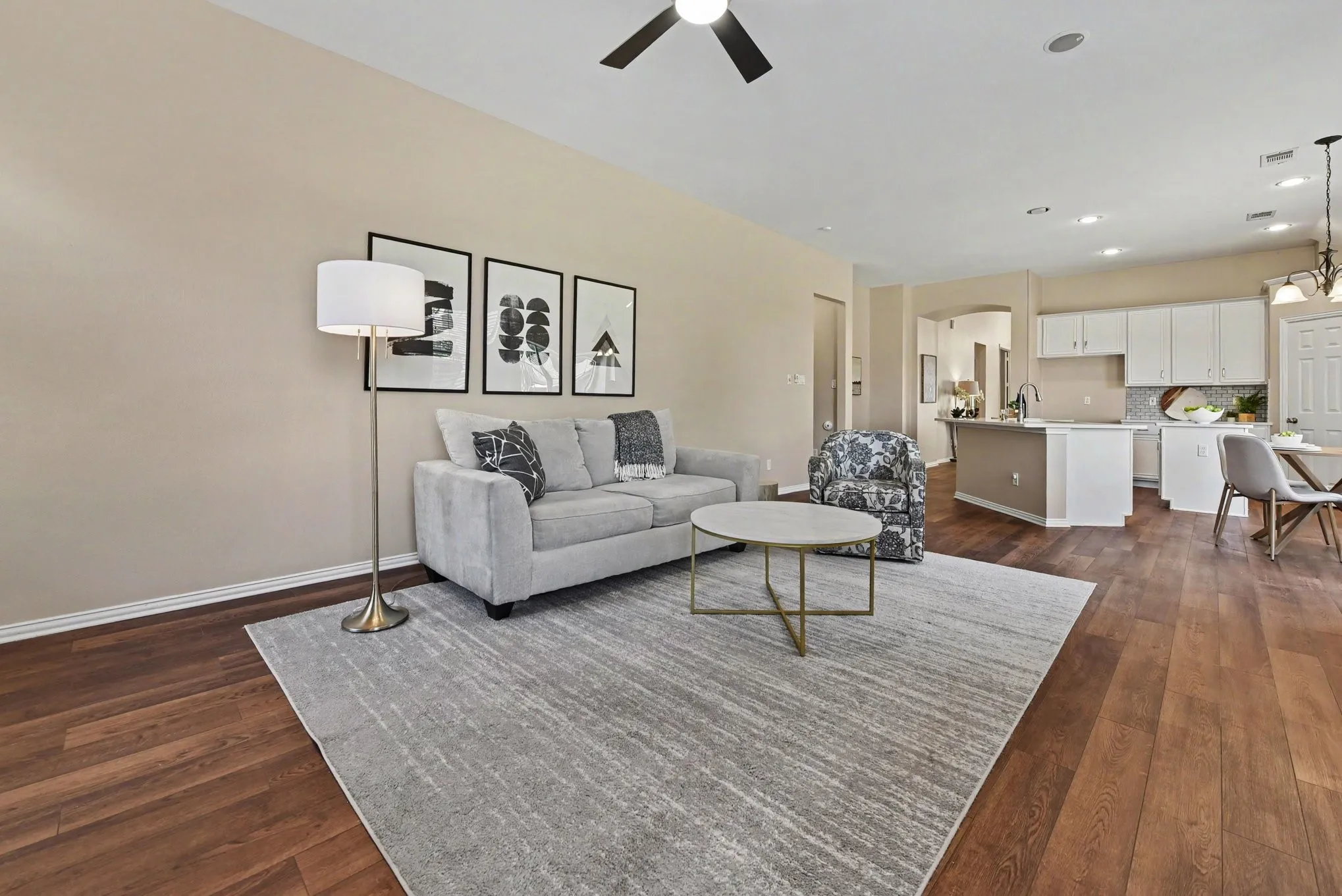 Spacious den with ceiling fan open to kitchen
