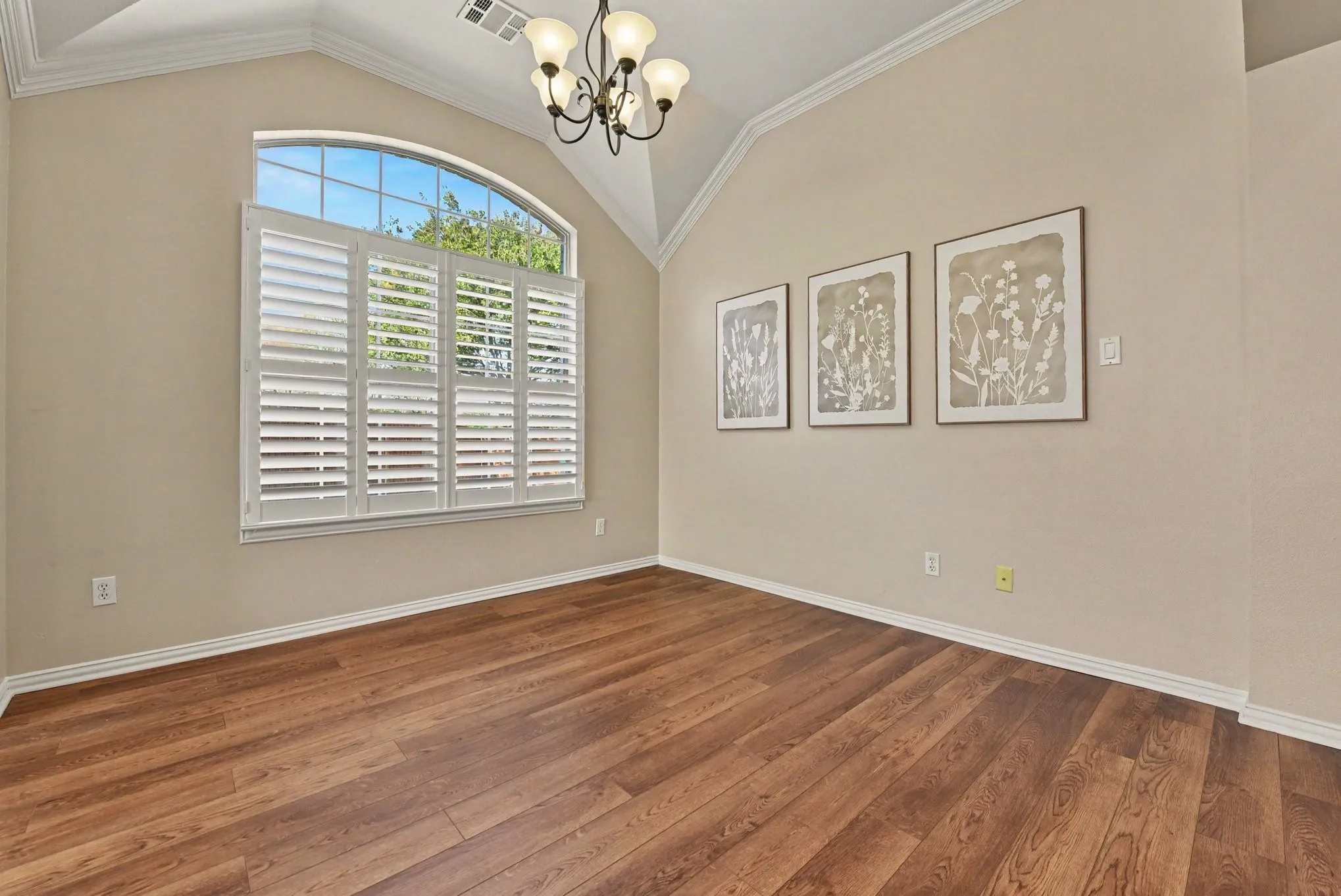 Dining room with chandelier and shutters