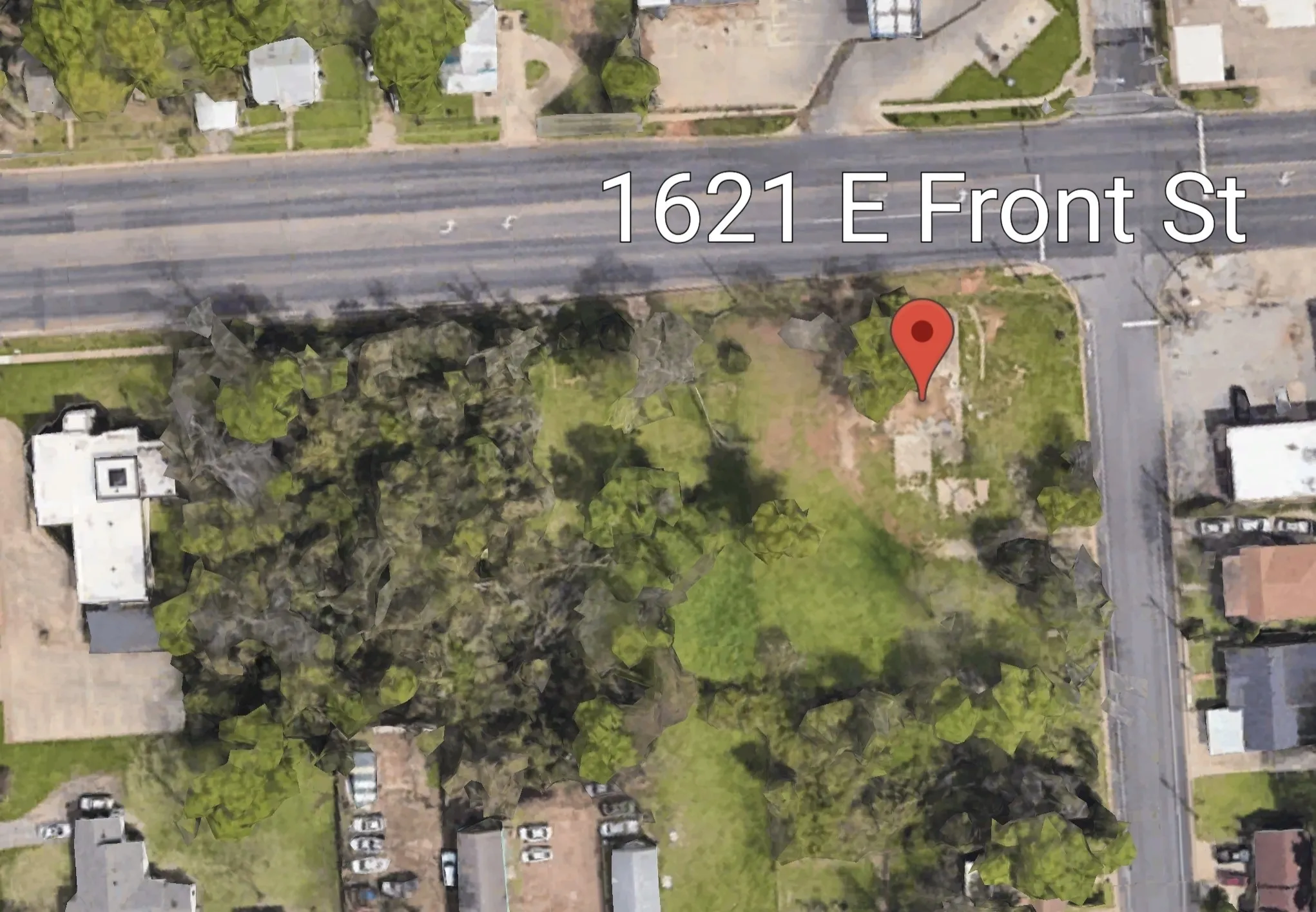 Corner parcel featuring mature tree coverage and direct road frontage