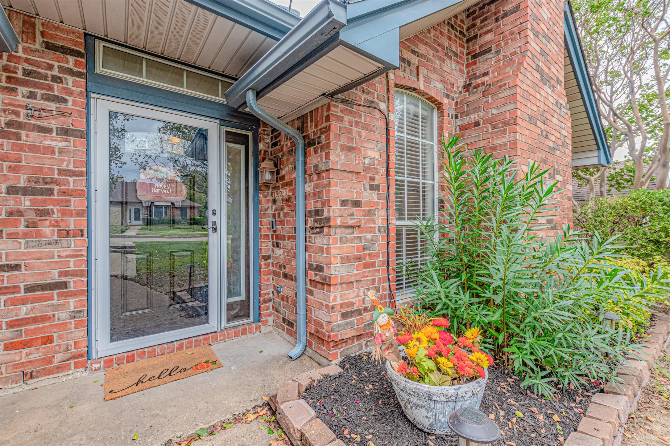 Welcoming front porch with door featuring keypad entry