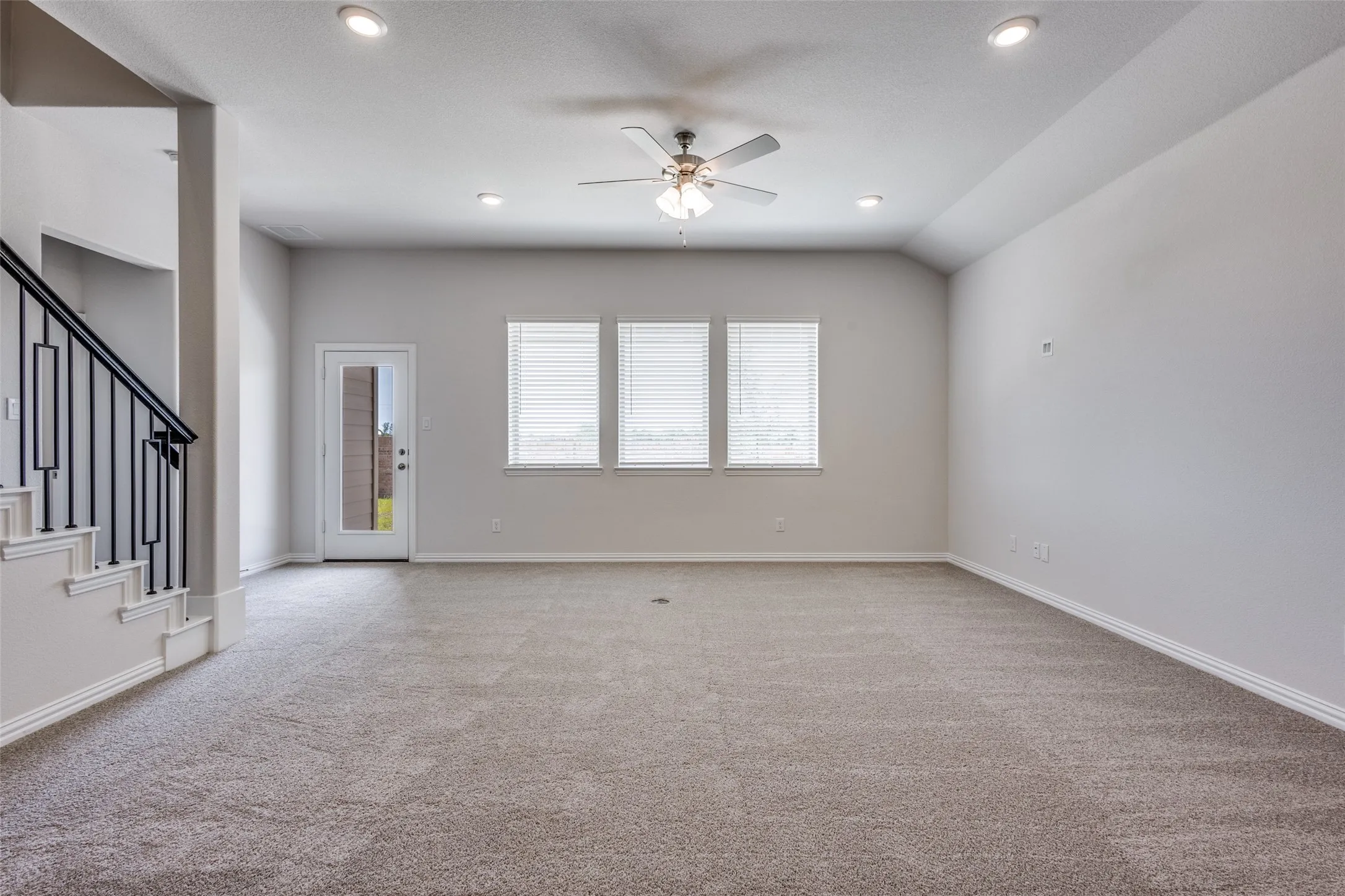 Unfurnished living room with stairs, carpet flooring, recessed lighting, and ceiling fan