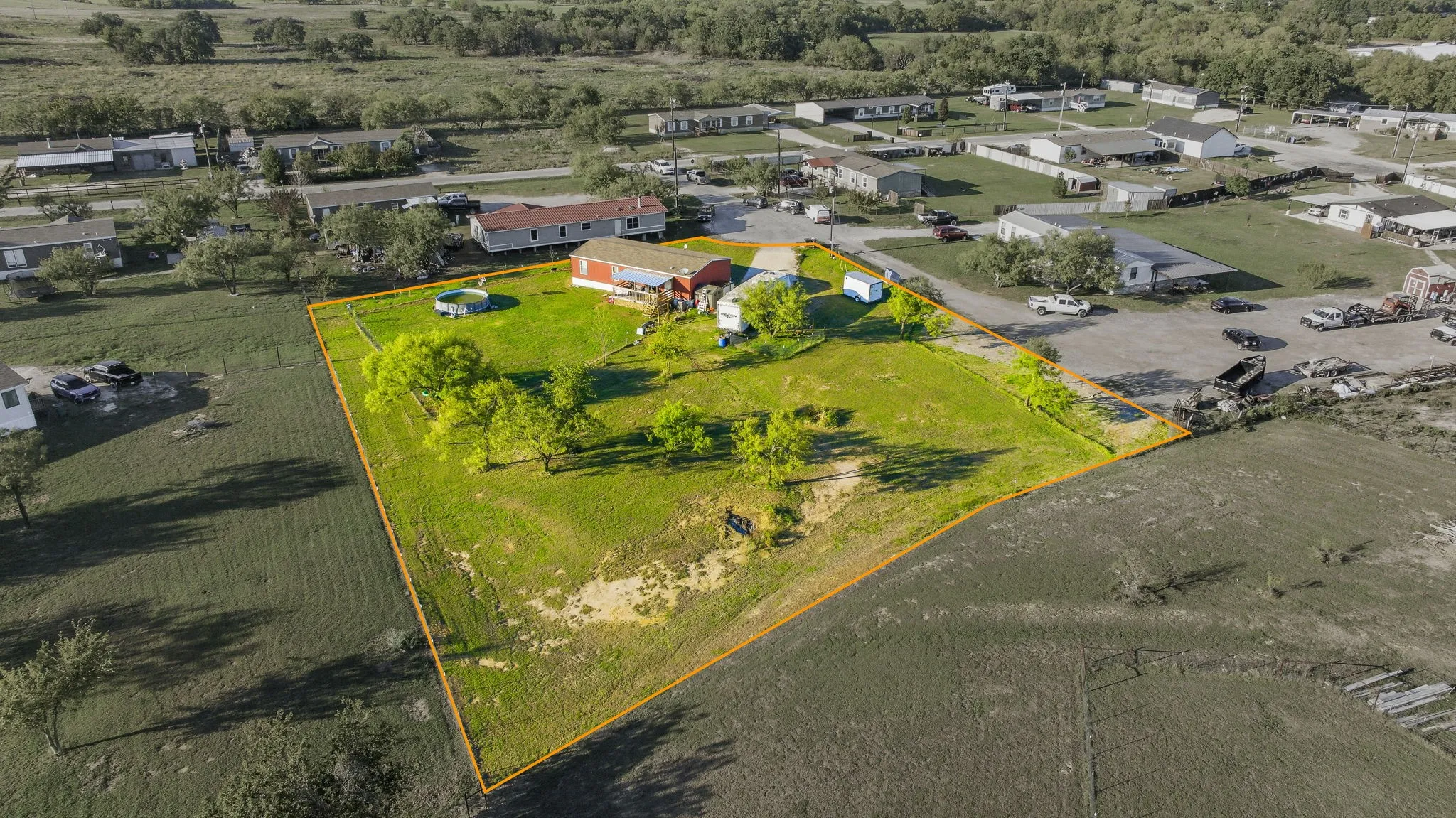 Expansive lot featuring mature trees, a fenced perimeter, and established lawn space