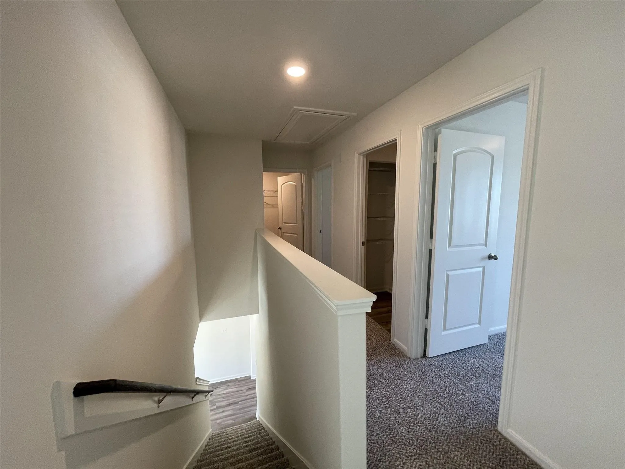 Neutral-toned interior featuring recessed lighting, carpeted flooring, and multi-panel interior doors