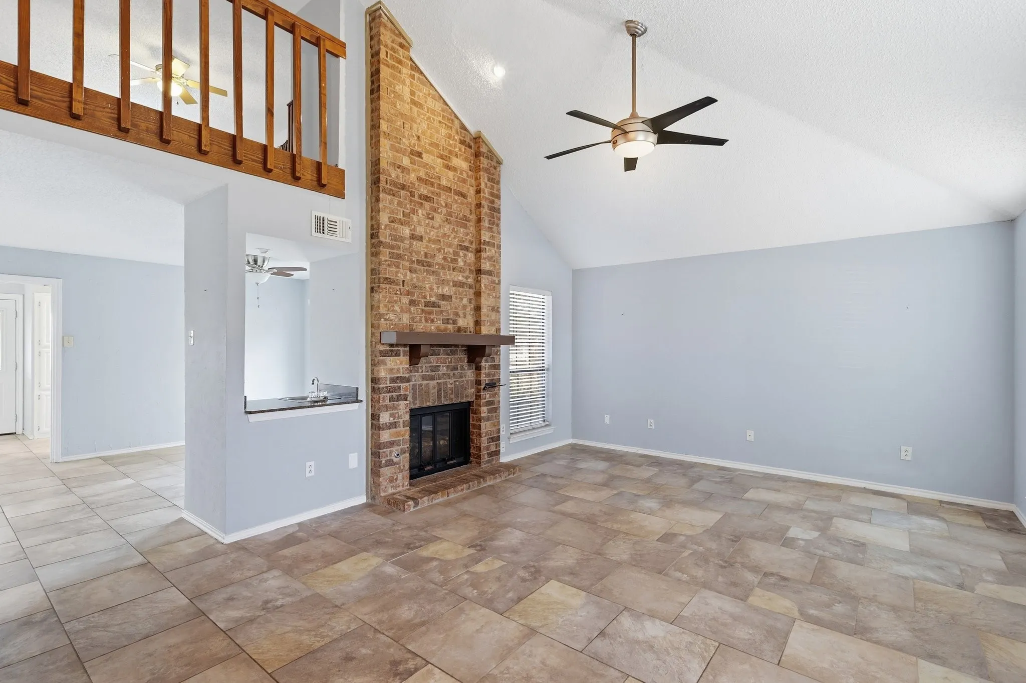 Family Room with fireplace and angled ceiling. Easy living on the ceramic tile instead of carpet!
